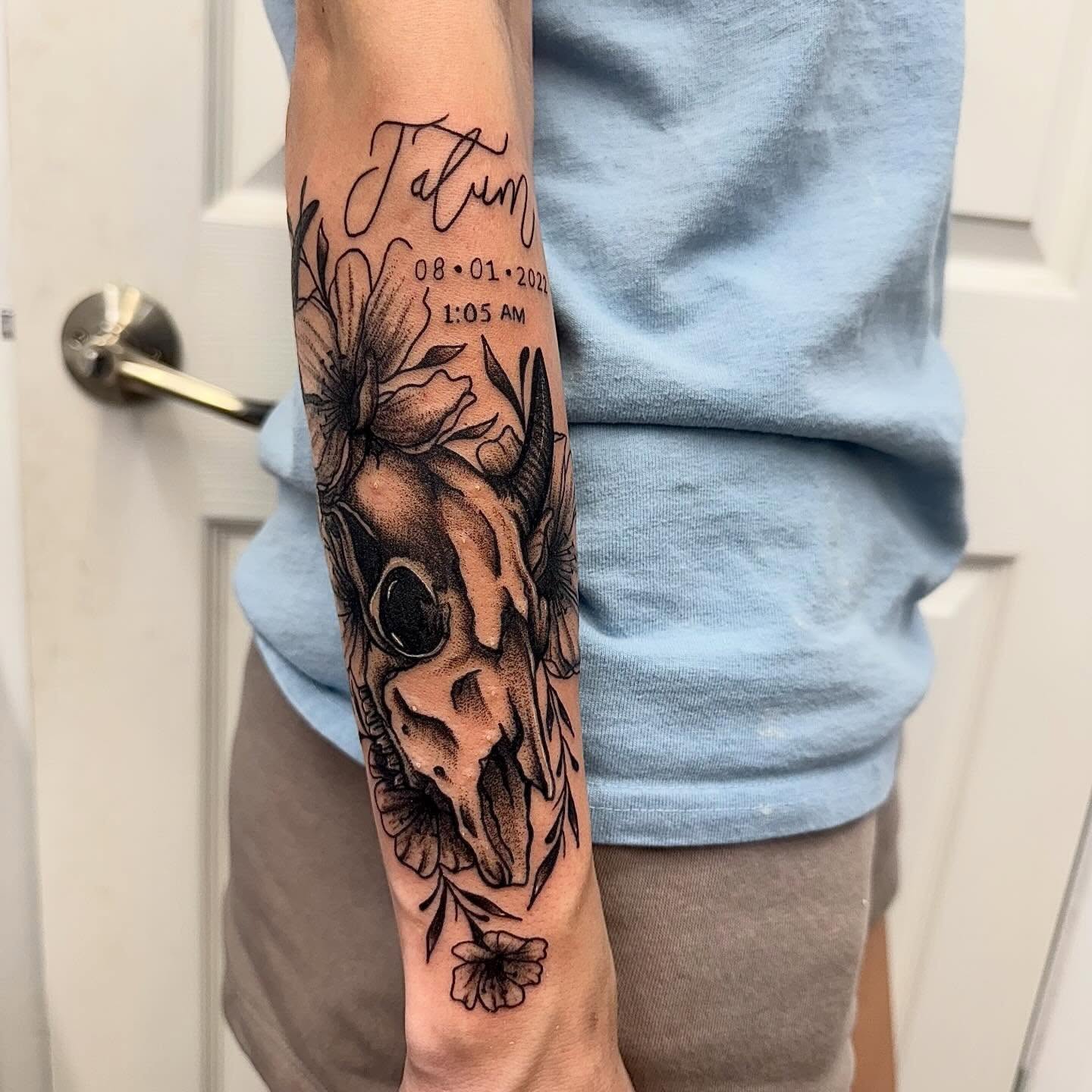 Cow skull with flowers black and grey tattoo on the forearm by Abby Ash, Belington, West Virginia