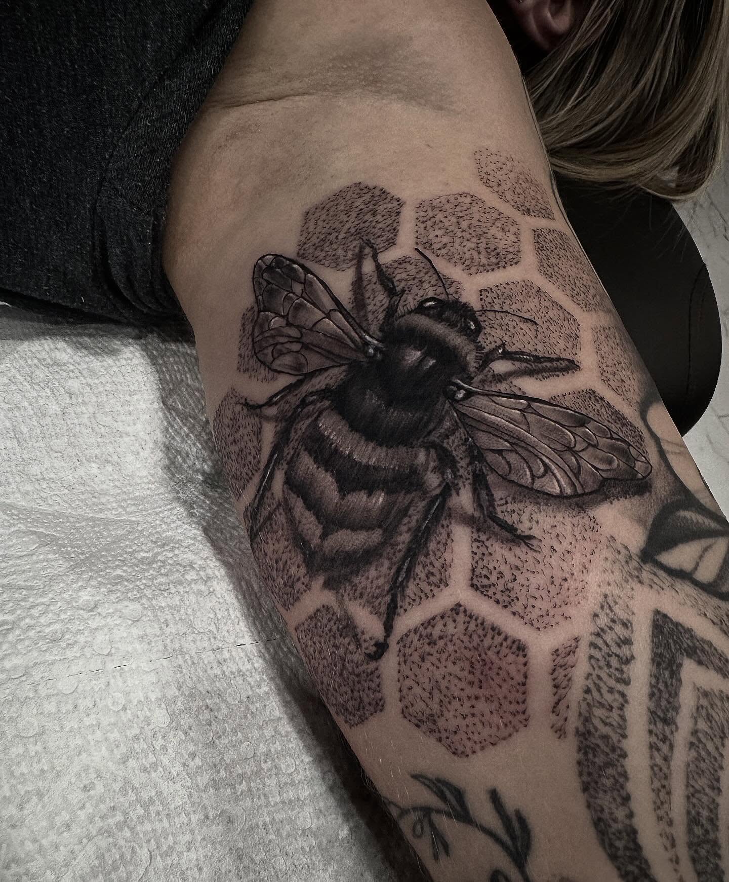 Bee and honeycomb dotwork tattoo on the forearm by Keith Smith
