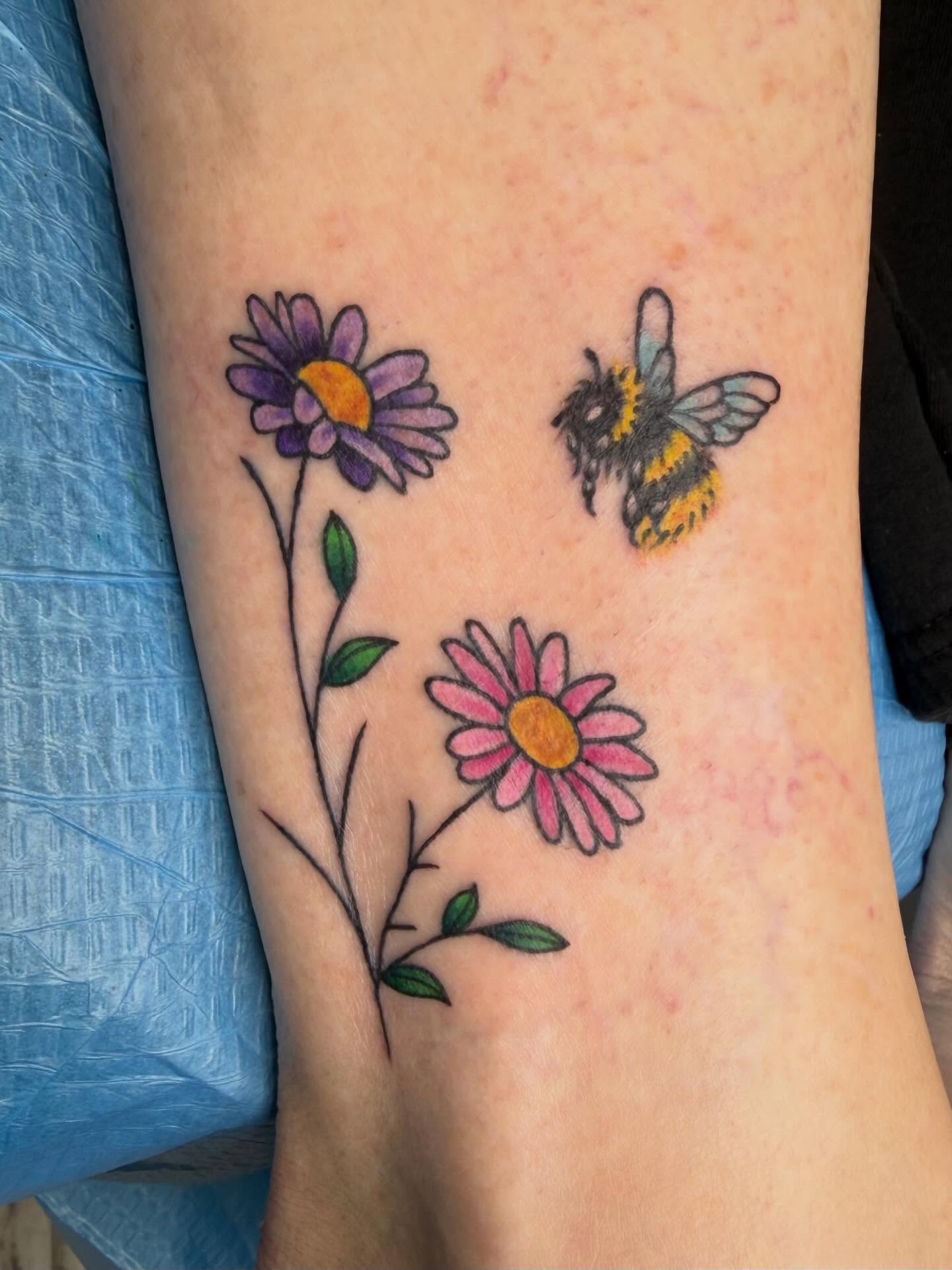 Flowers and bee new school tattoo on the forearm by linda perez