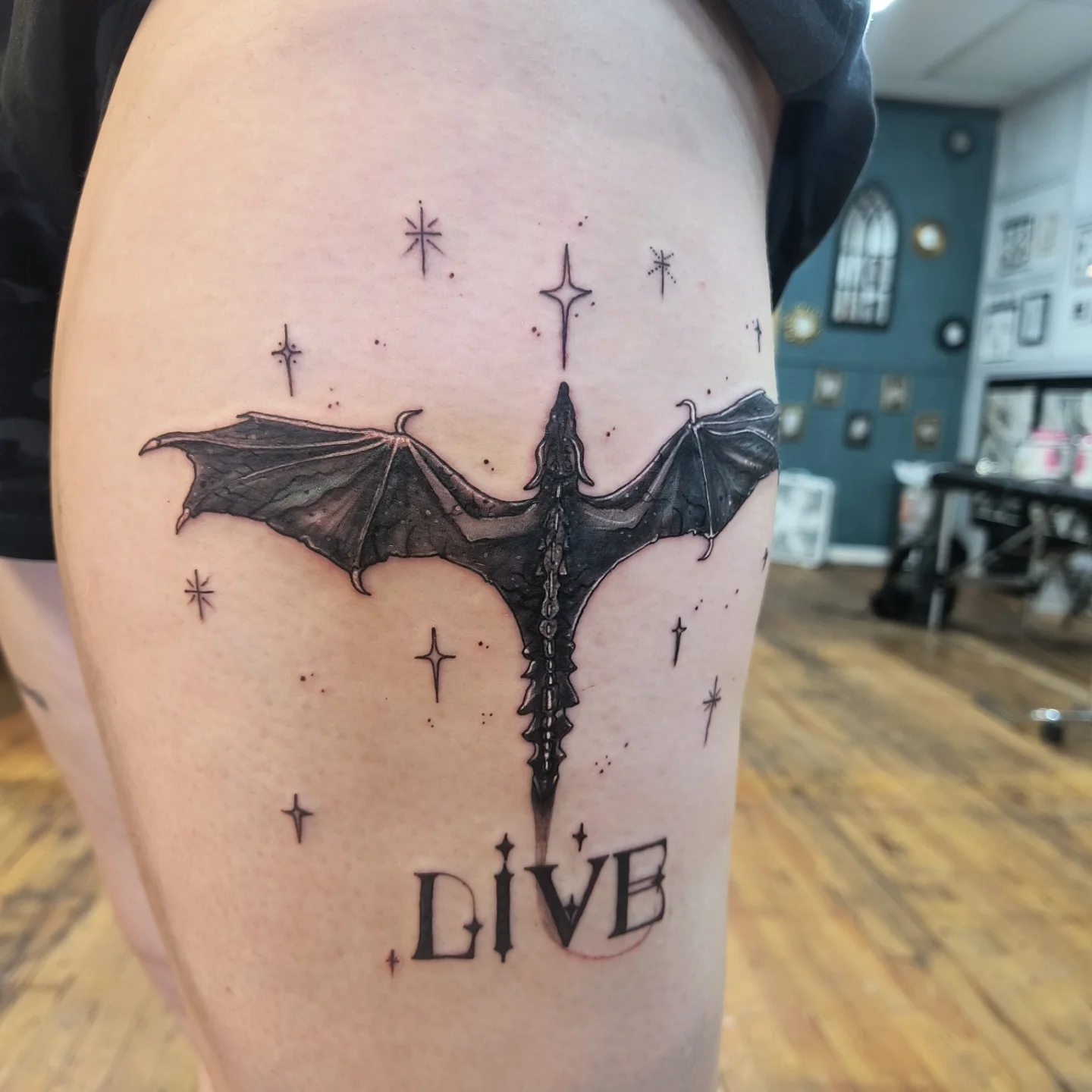 Bat and stars black and grey tattoo on the thigh by Niki Jackson