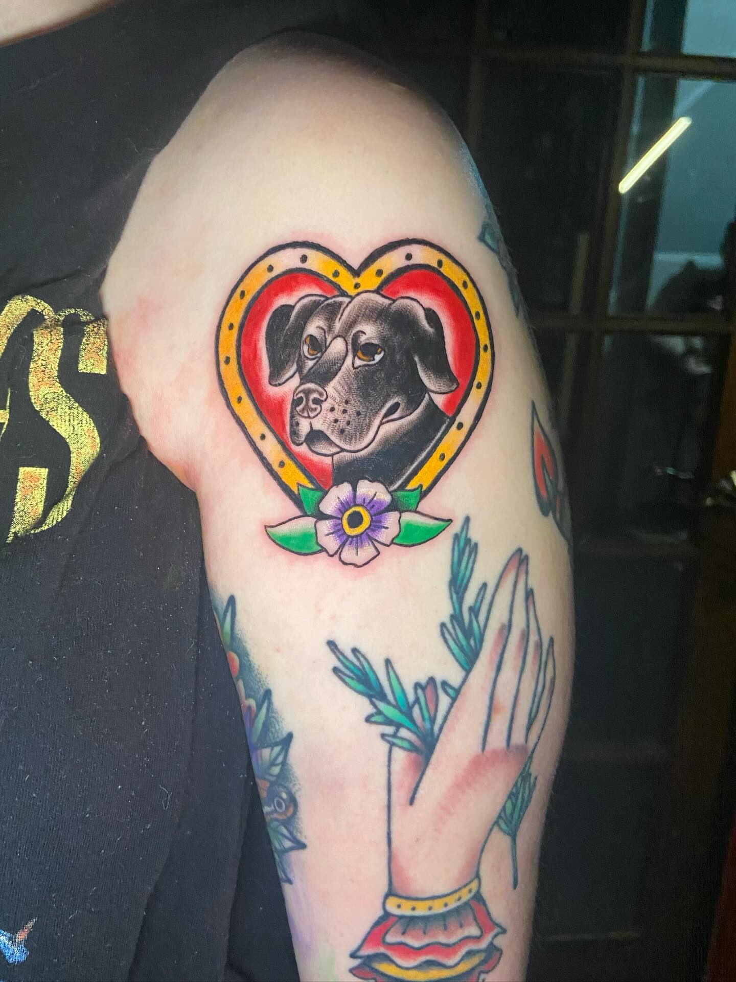 Dog within heart American traditional tattoo on the upper arm by 🐆Cam Feral Tattoos