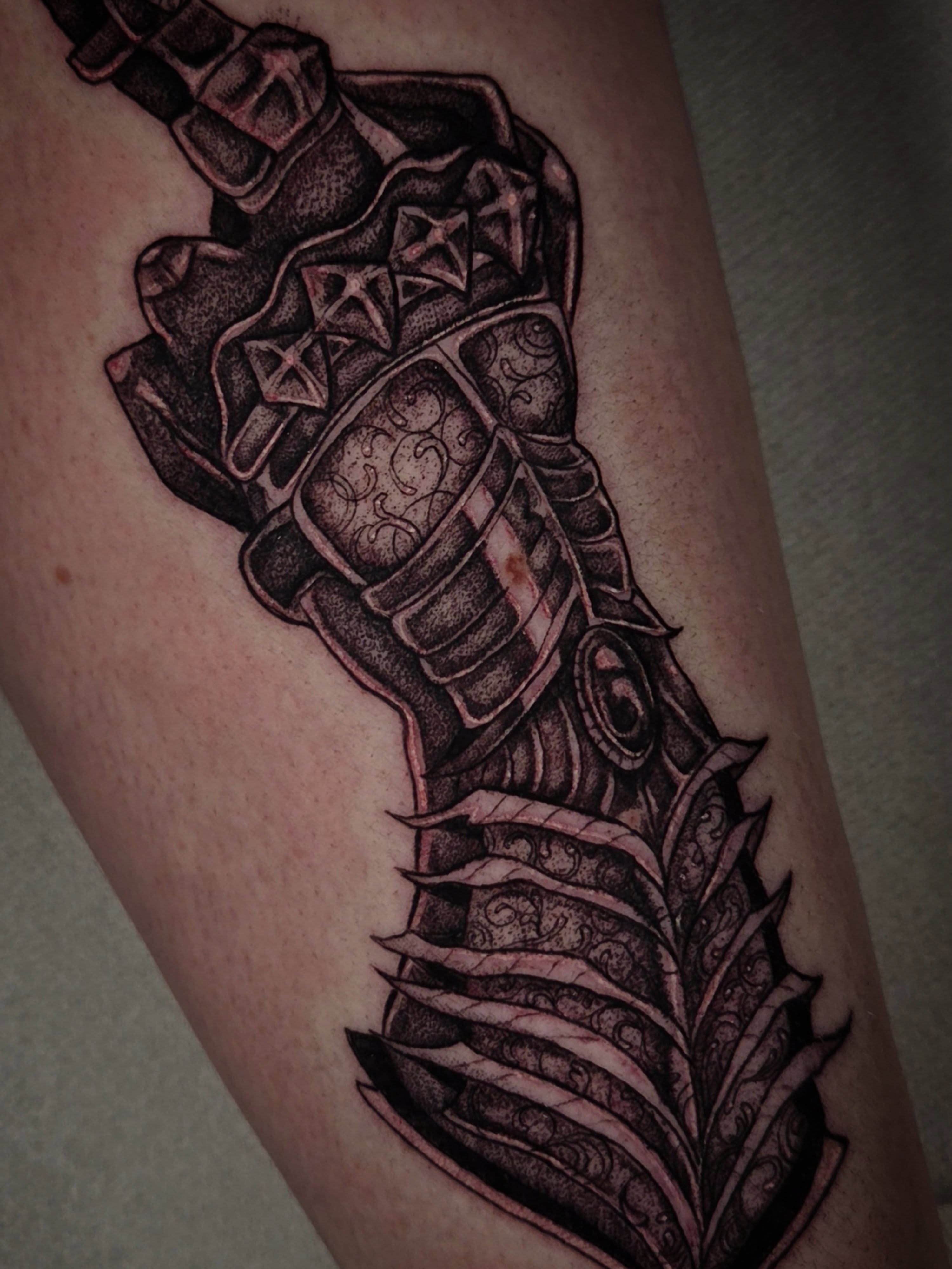 Sword and armor realism tattoo on the forearm by Devin 🖤