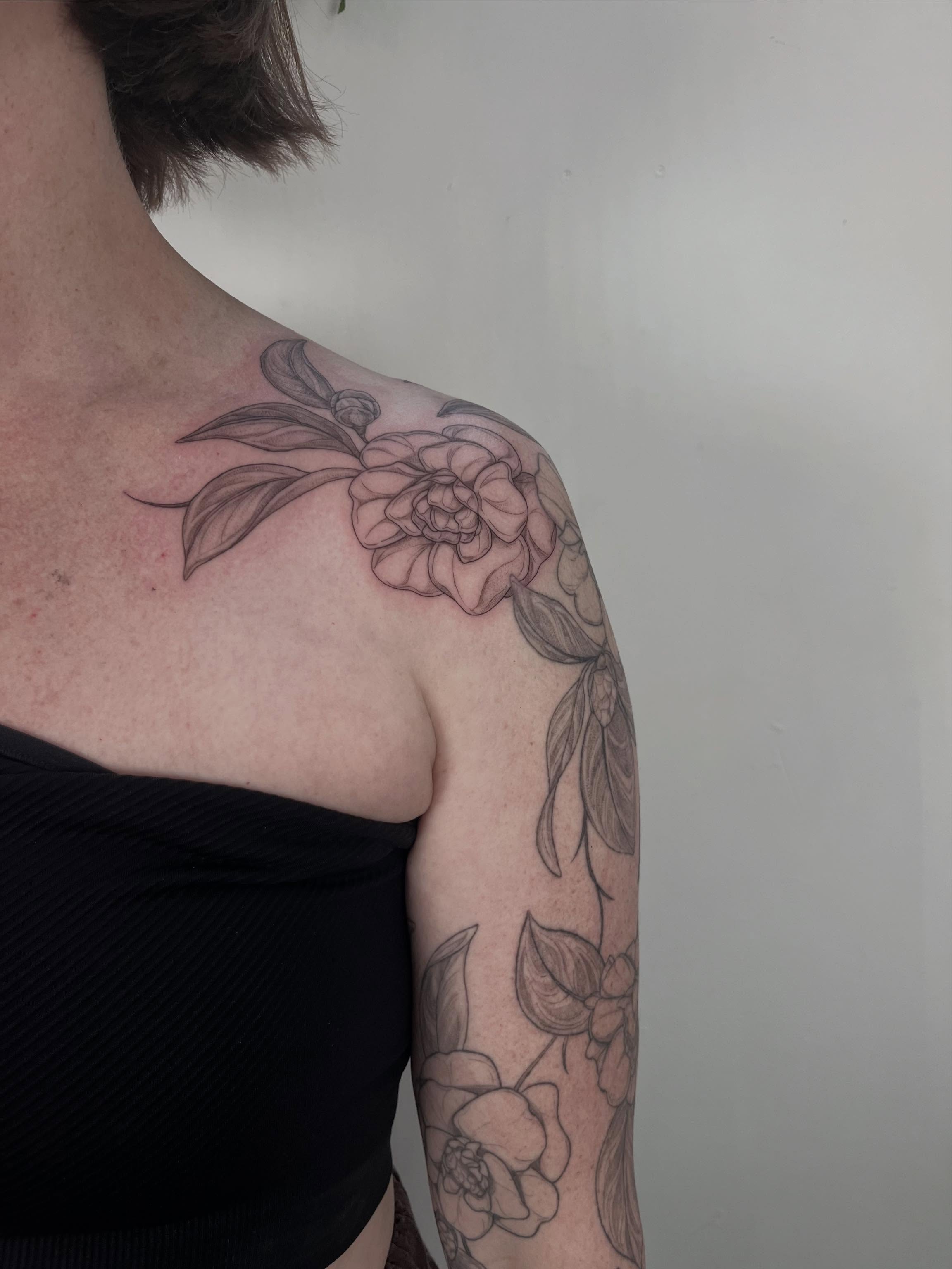 Peony black and grey tattoo on the shoulder by Sierra Skye
