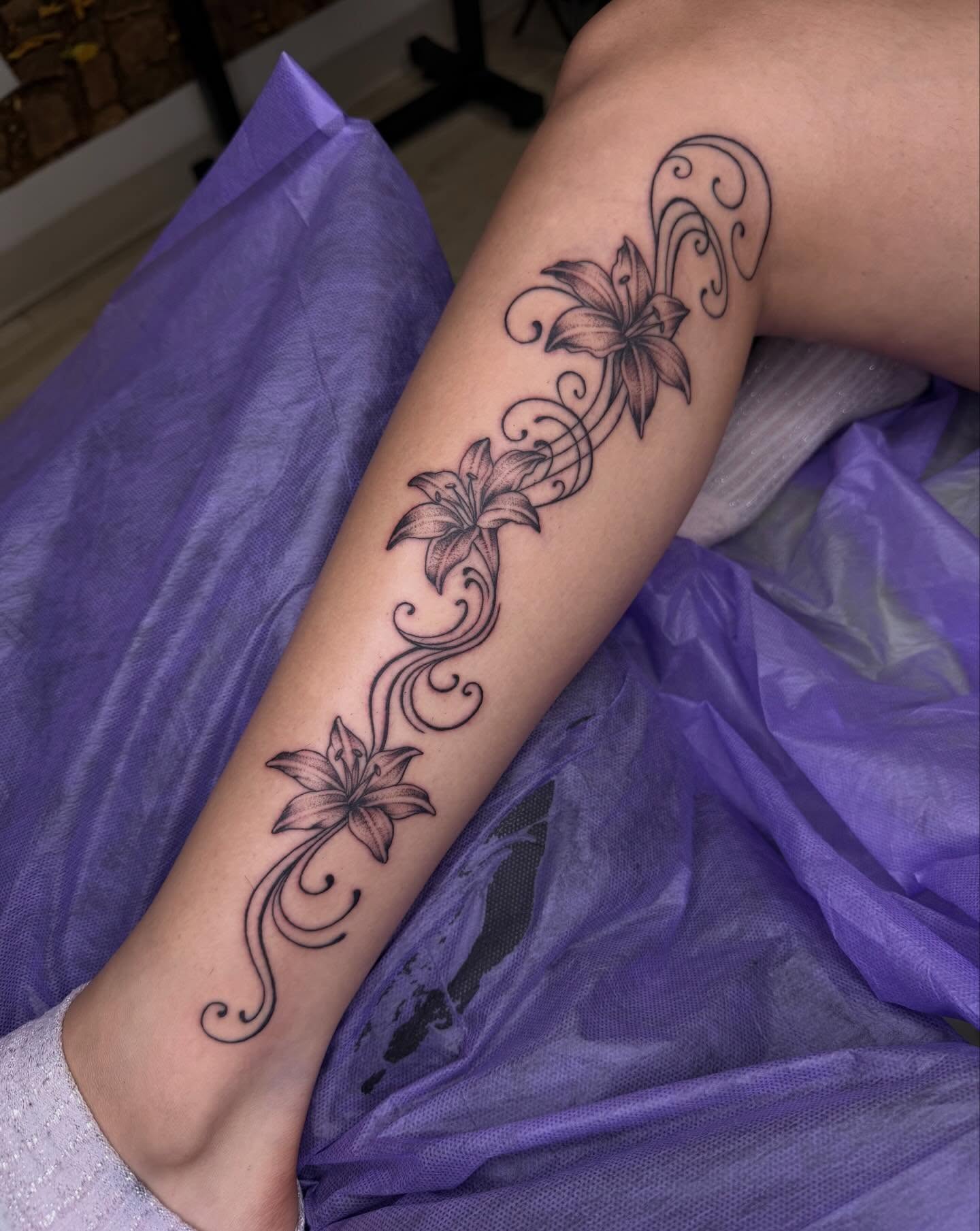 Lilies black and grey tattoo on the forearm by Nadia ★