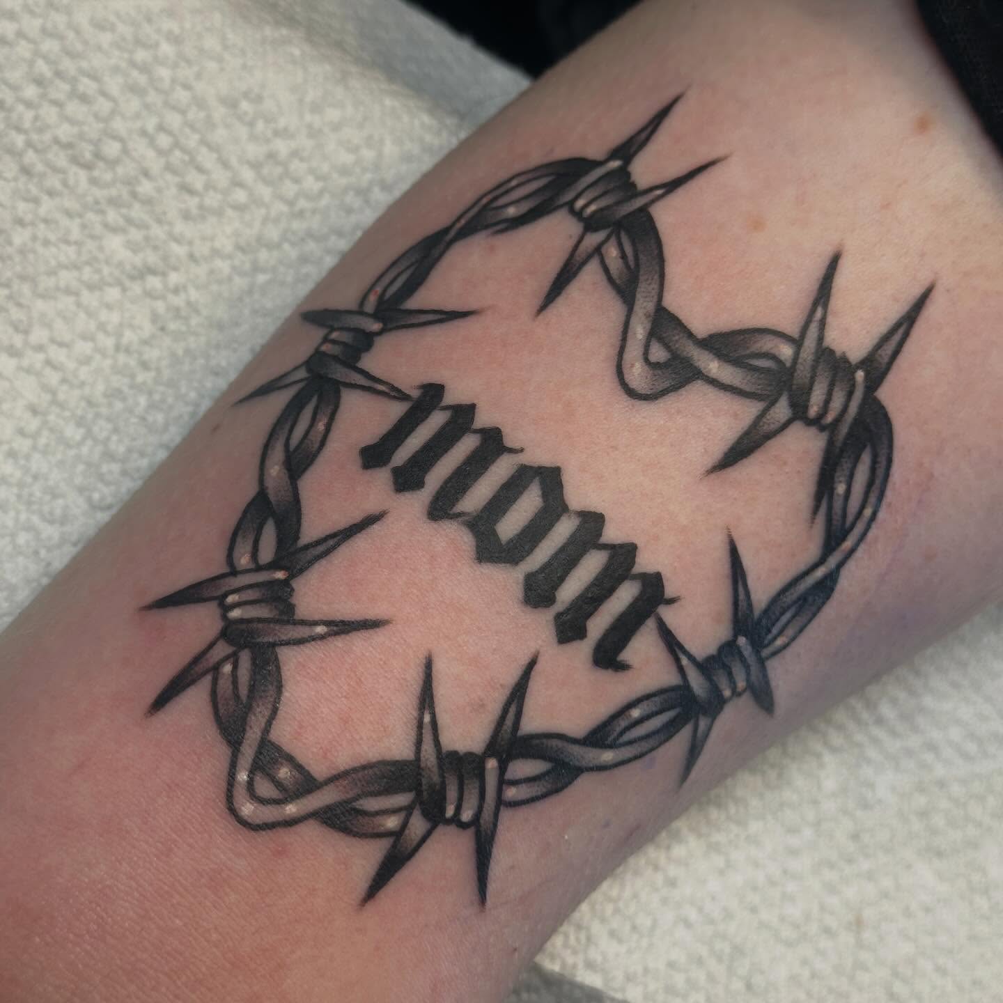 Barbed wire black and grey tattoo on the forearm by Elisha B🦷