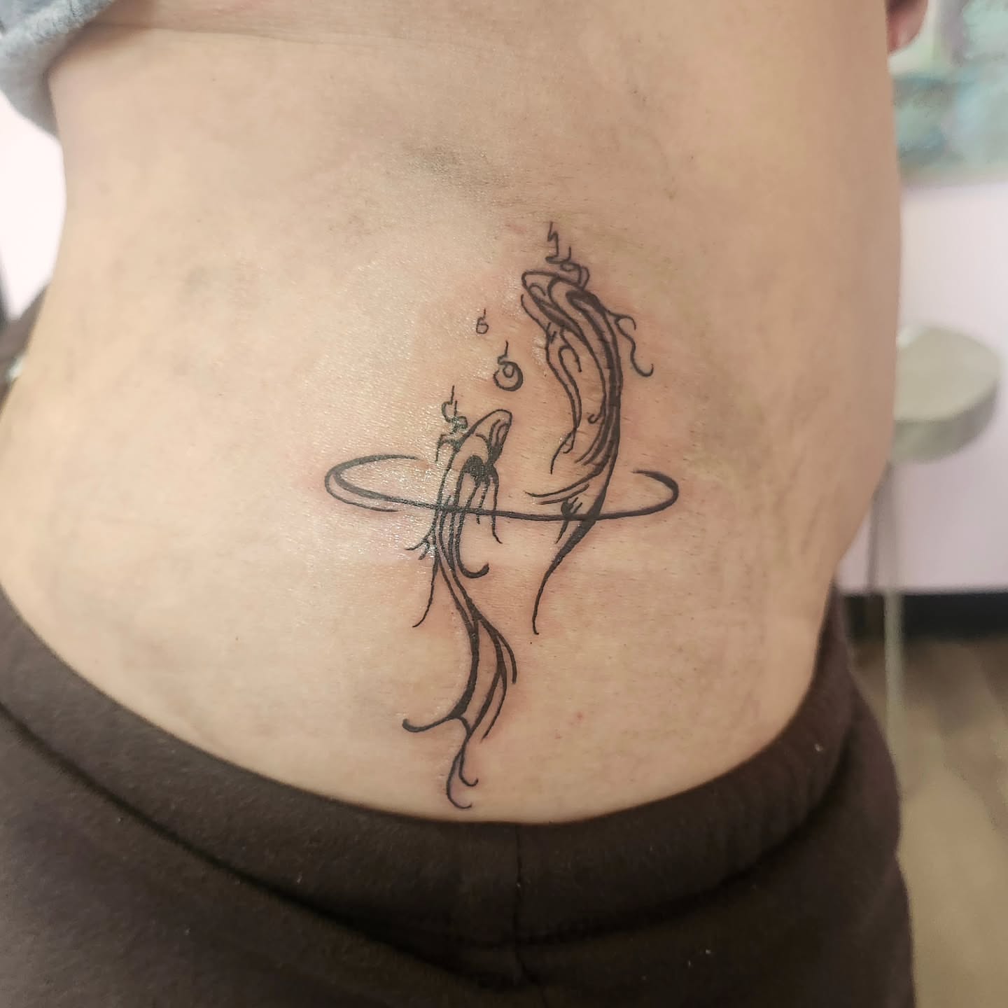 Fish and ring black and grey tattoo on the torso by Meredith 🎈 Tattoo the Bride ✝️