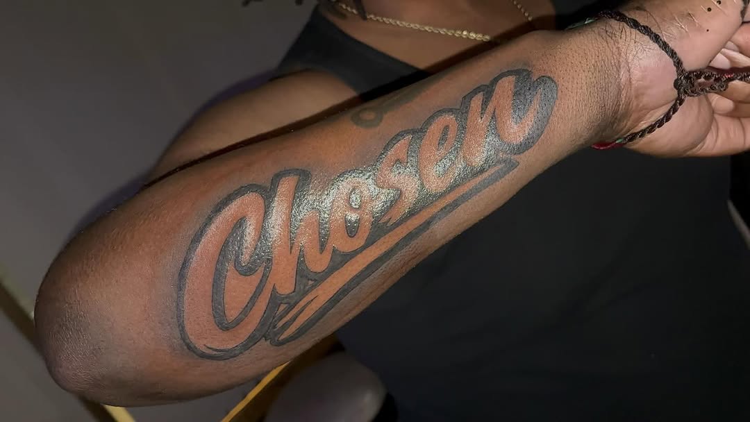 Chosen script lettering lettering tattoo on the forearm by TP