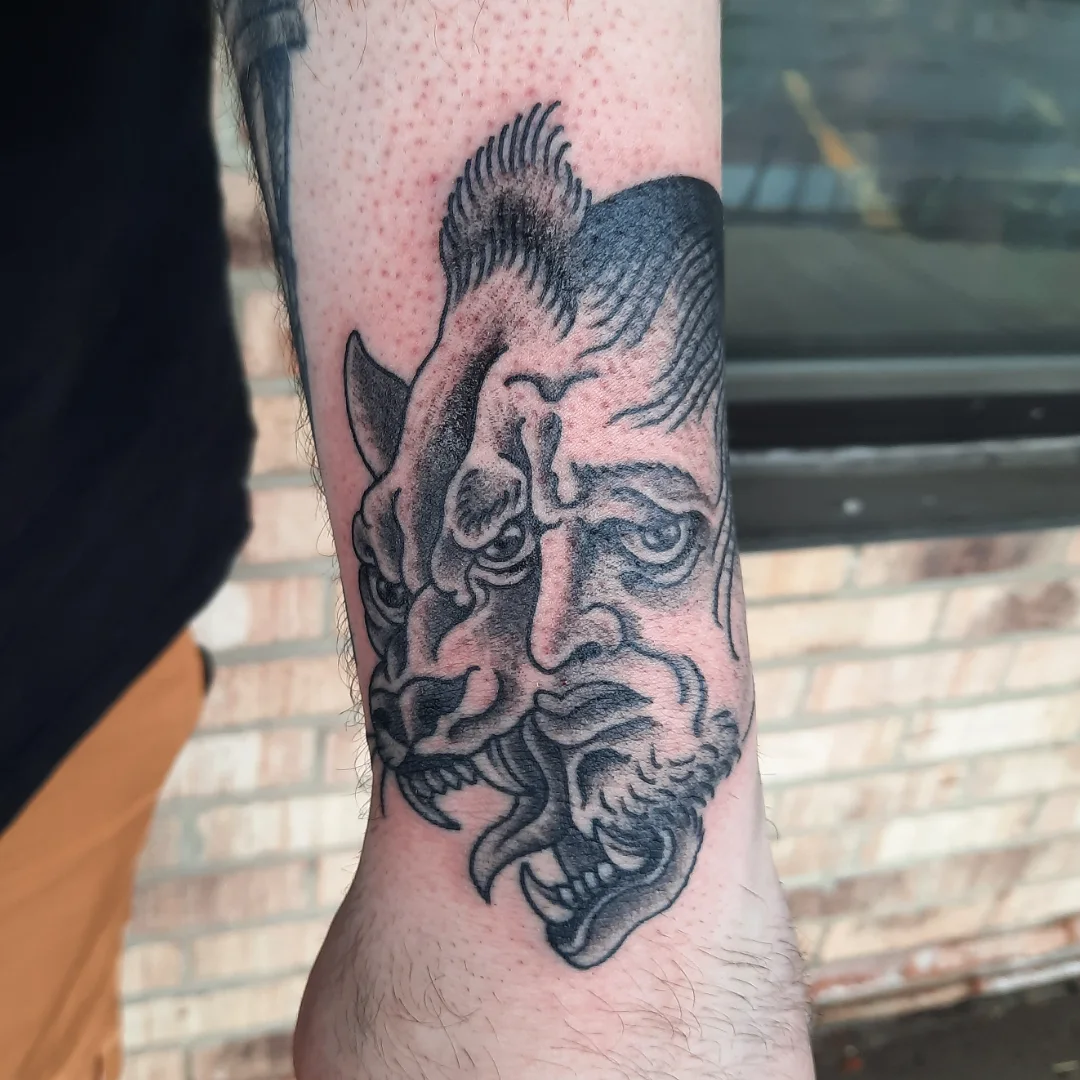 Man's face with animal realism tattoo on the forearm by Kaetlyn