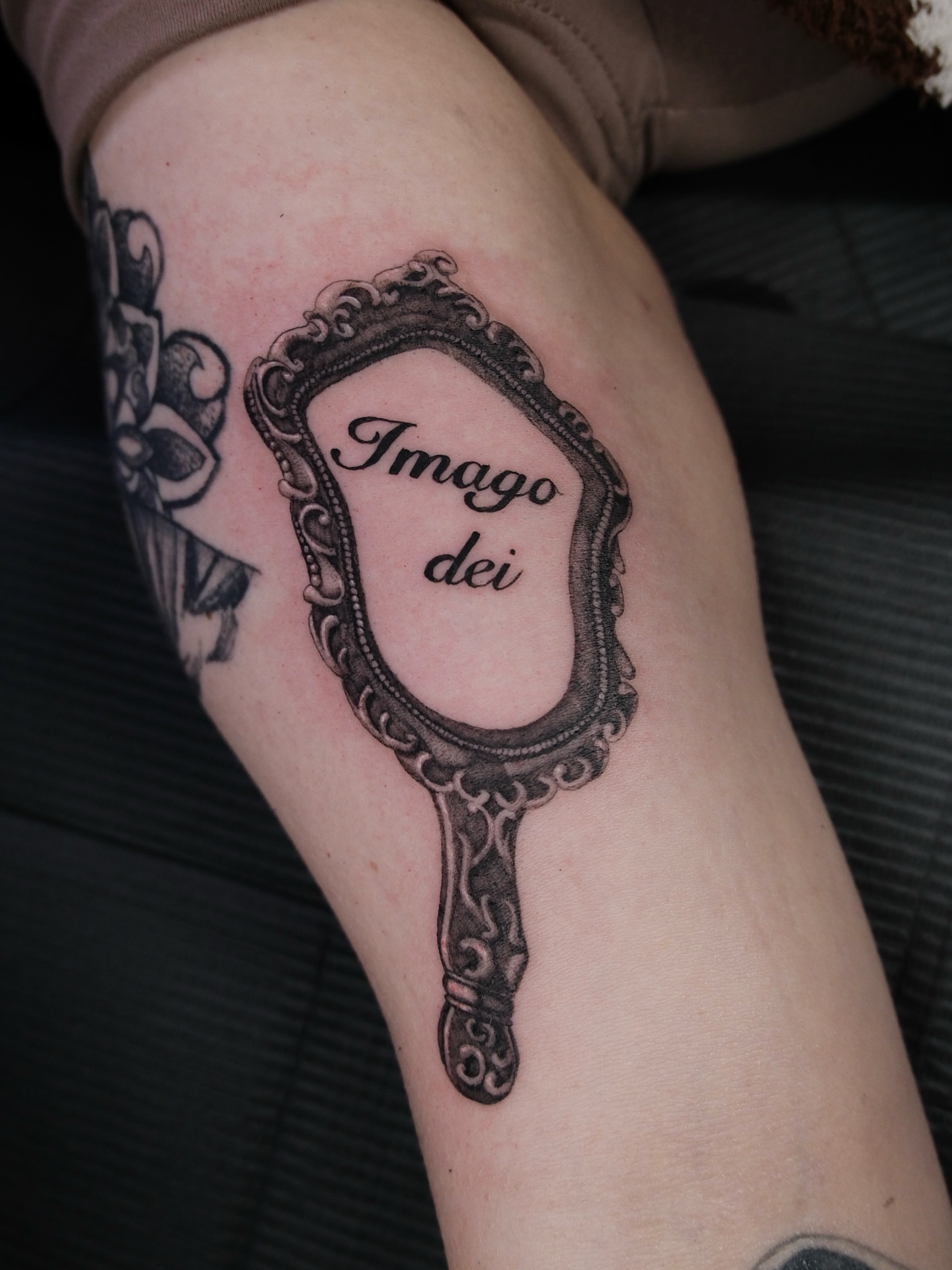 Mirror black and grey tattoo on the forearm by Kiana Hope
