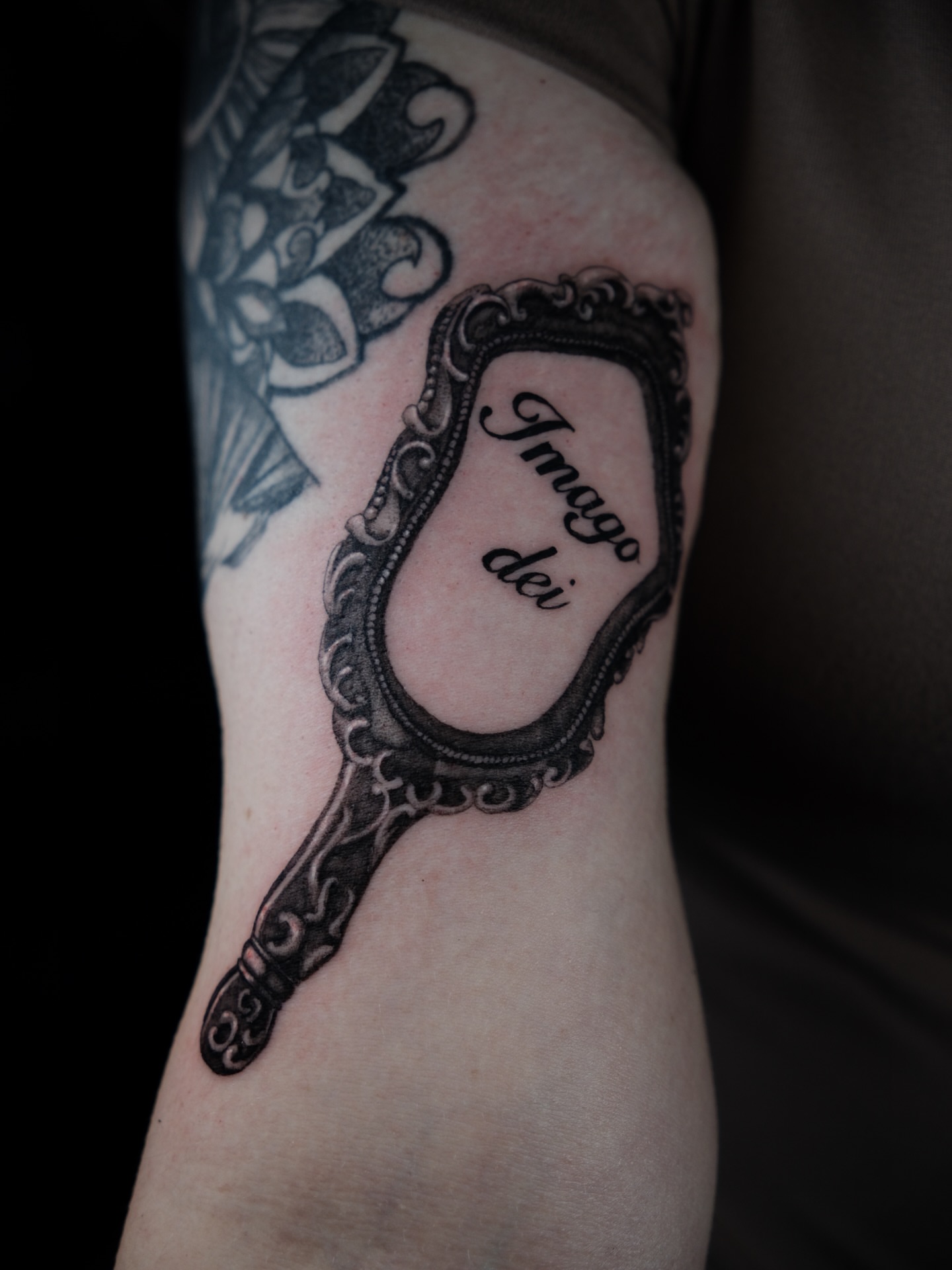 Mirror black and grey tattoo on the forearm by Kiana Hope