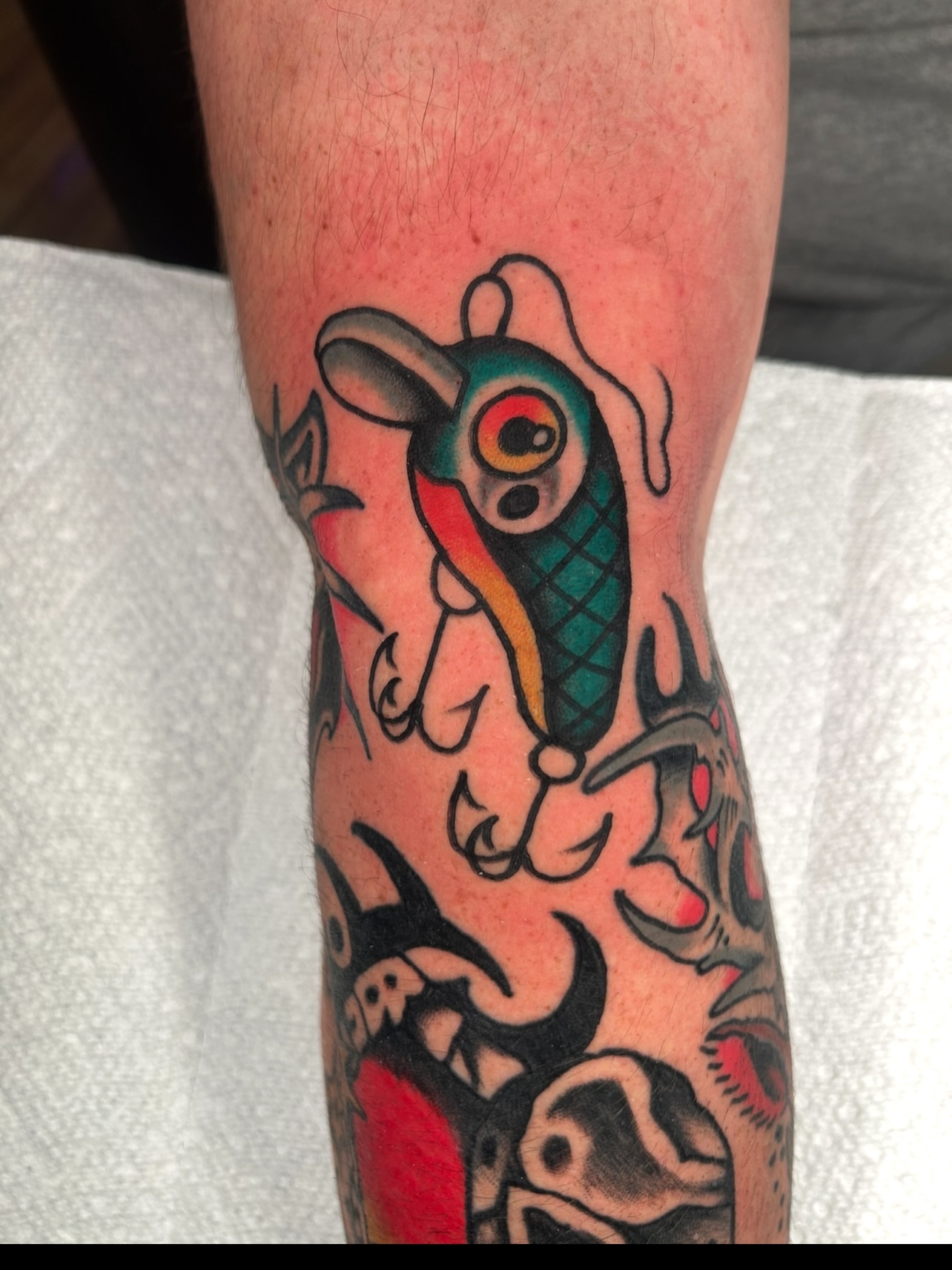 Fish and hook American traditional tattoo on the forearm by Kit Miller, Indianapolis, Indiana