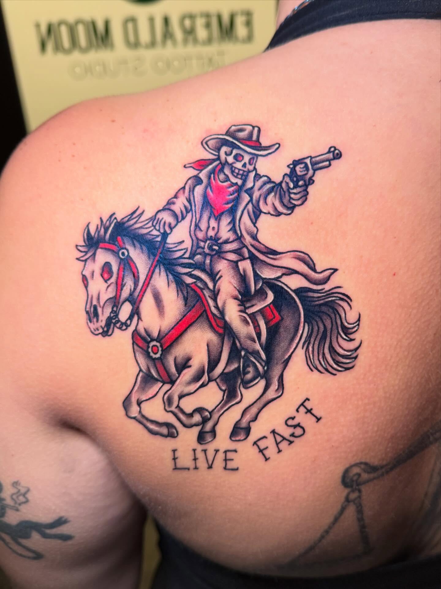 Cowboy skeleton on horse American traditional tattoo on the shoulder by Madison Pegram