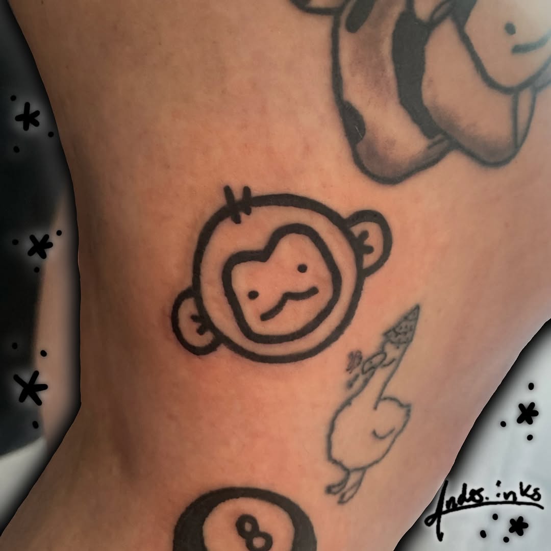Monkey face tattoo on the forearm by ande