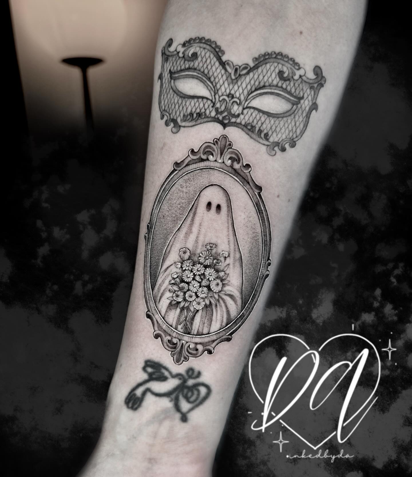 Mask and ghost ornamental tattoo on the forearm by Dalton Alexandria