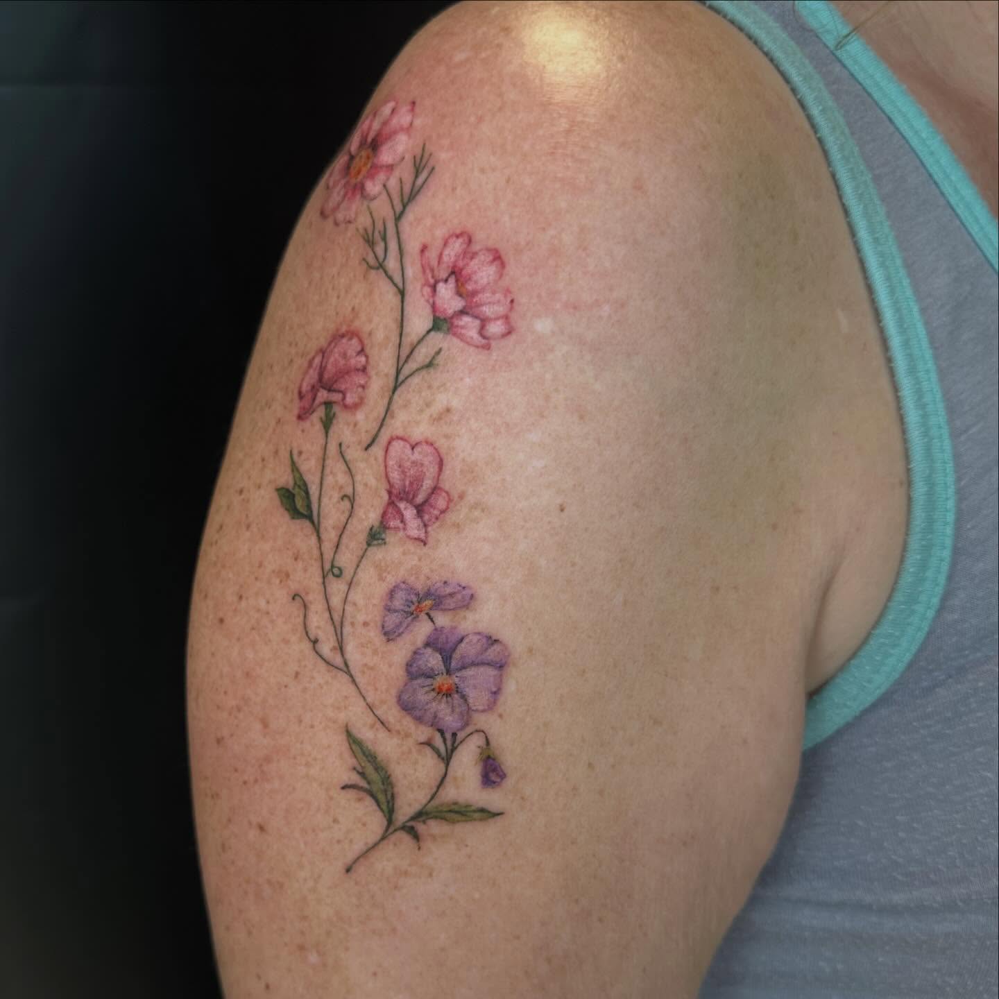 Flowers watercolor tattoo on the shoulder by Sam, Mount Laurel, New Jersey