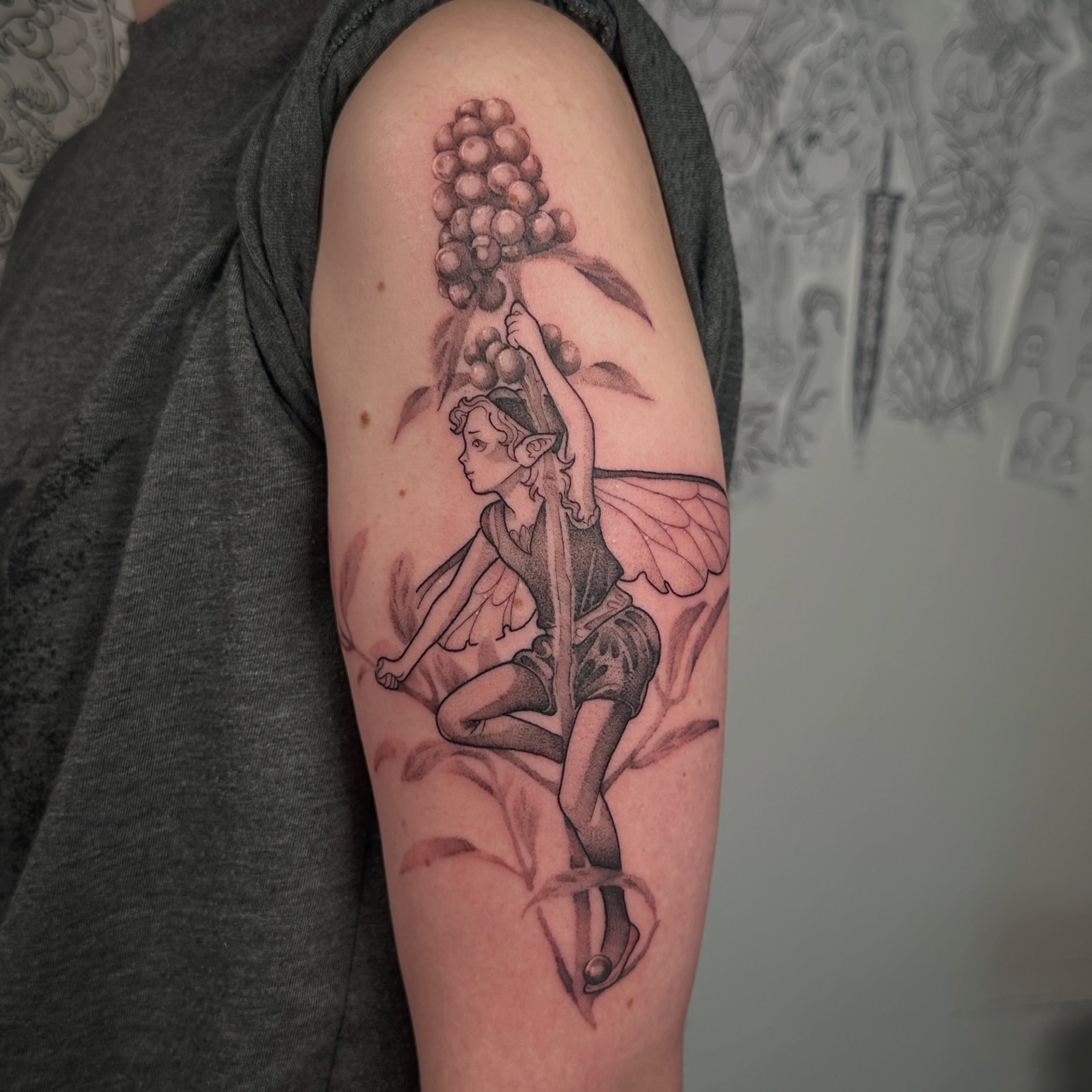 Fairy with grapes black and grey tattoo on the forearm by TATTOOLIZARD (James)