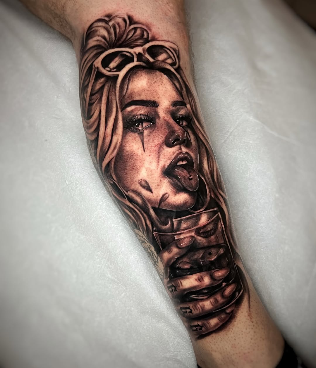 Woman with drink realism tattoo on the forearm by Blot_Tattoo