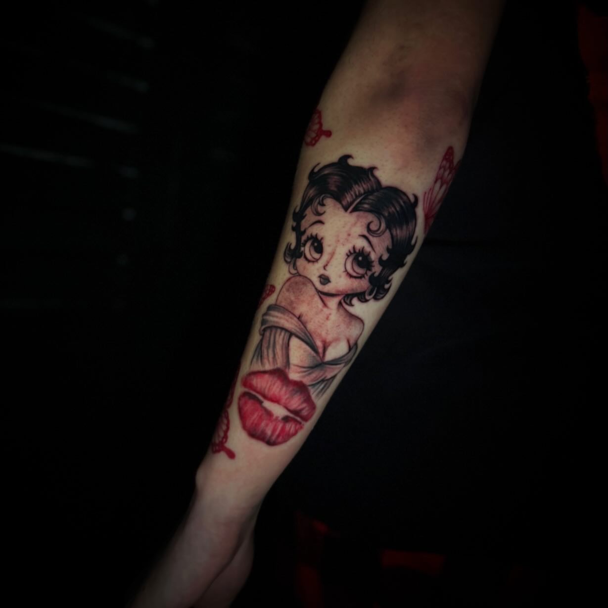 Betty Boop American traditional tattoo on the forearm by Sad Girl Tattoos