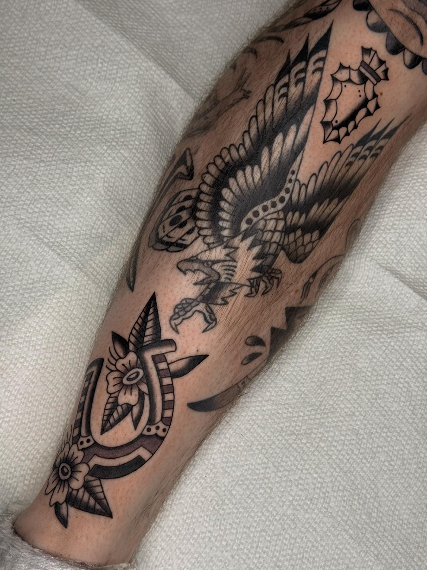 Bird and floral American traditional tattoo on the forearm by Bridgette Carberry