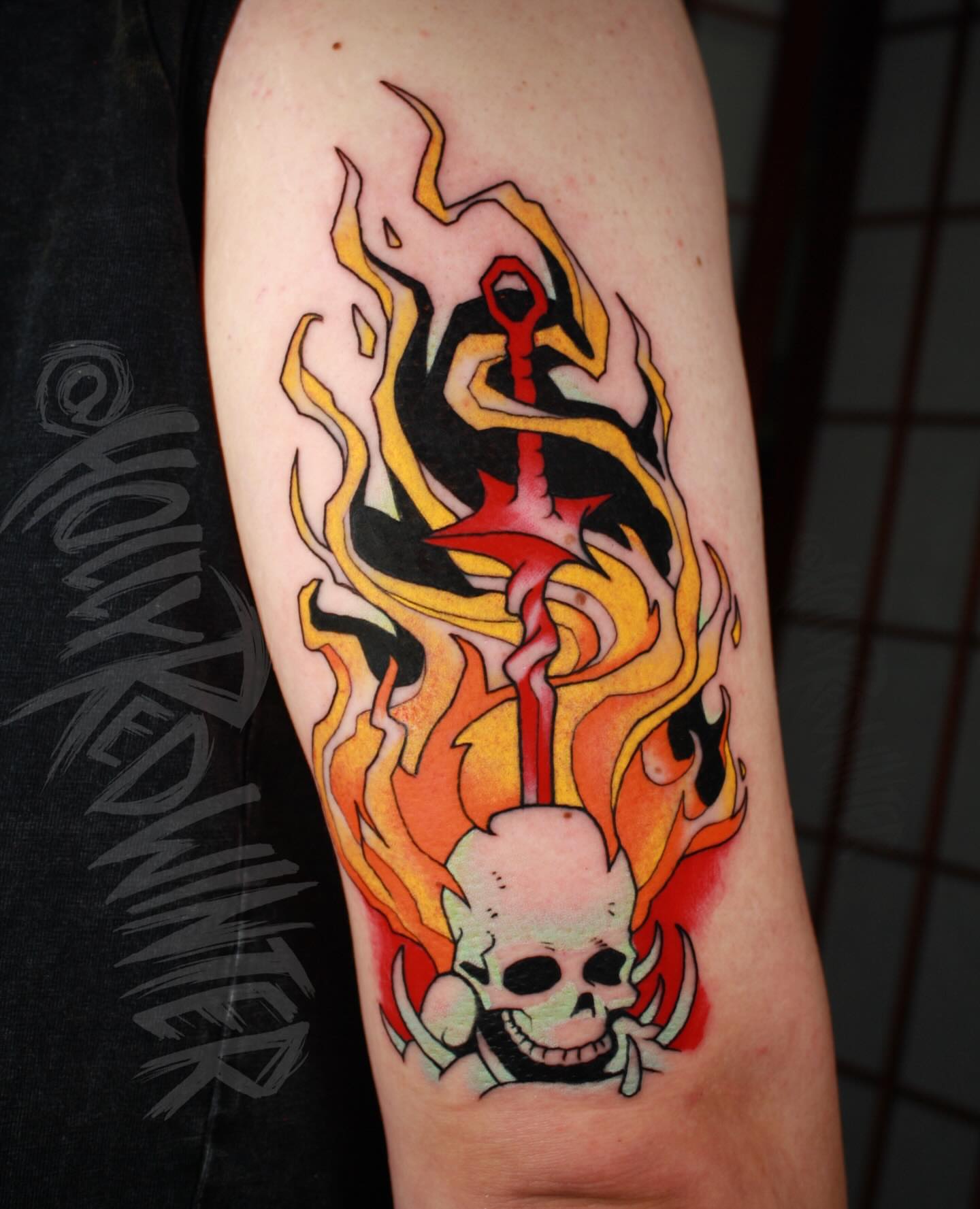 Flaming skull American traditional tattoo on the forearm by Holly Redwinter