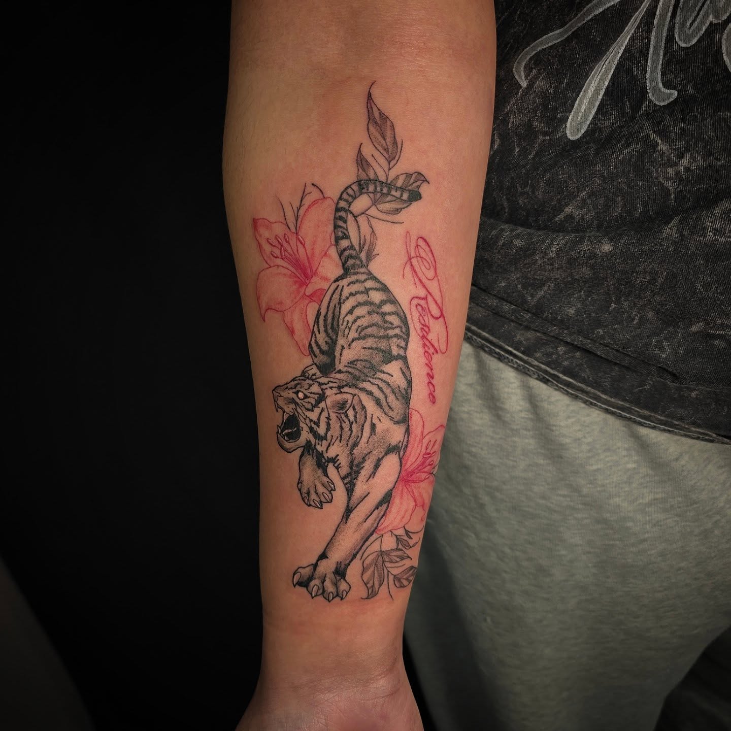Tiger and flowers black and grey tattoo on the forearm by Linda Marroum, Morningside, Maryland