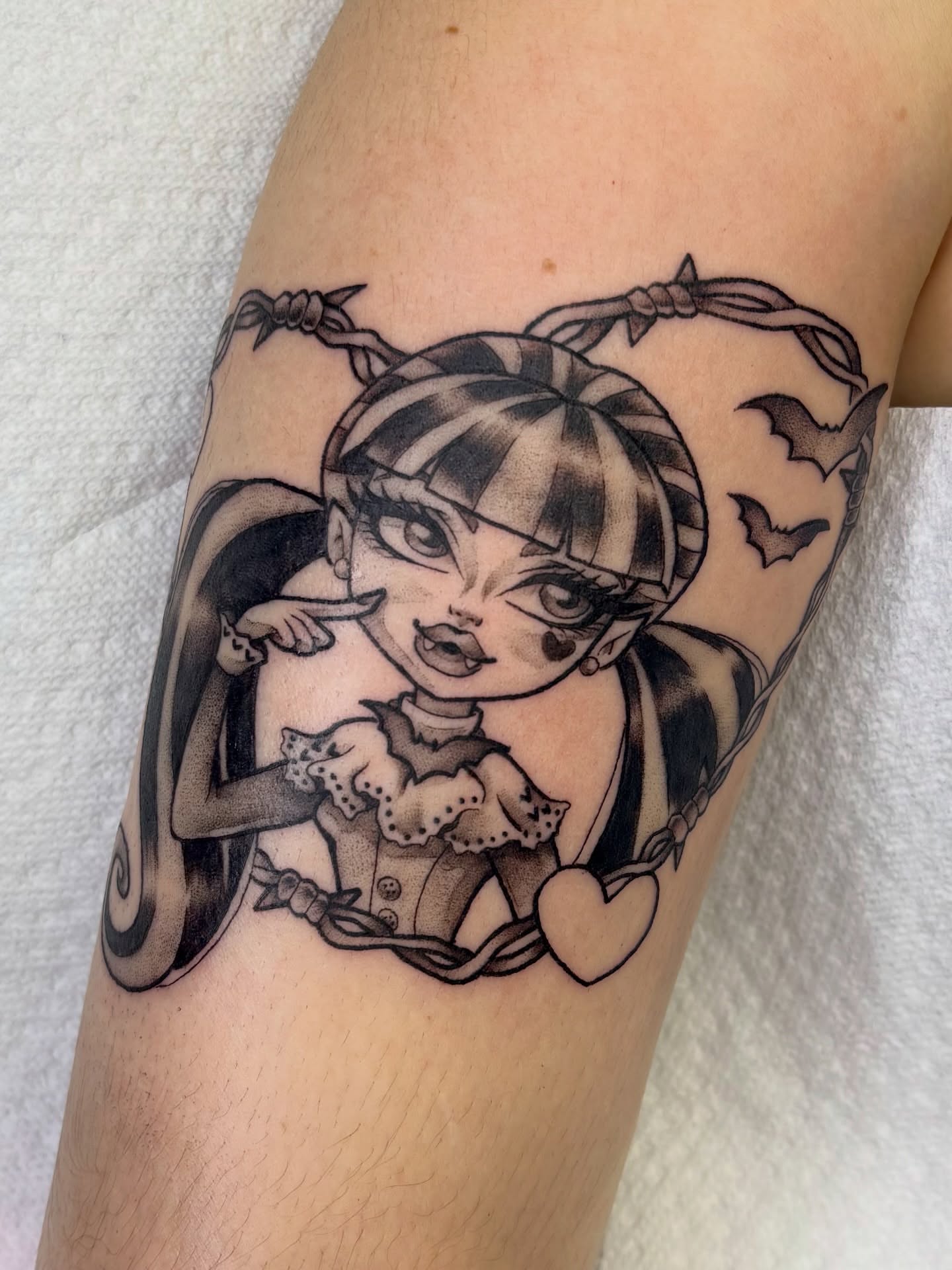 Doll with barbed wire dark realism tattoo on the forearm by Lilac Rose