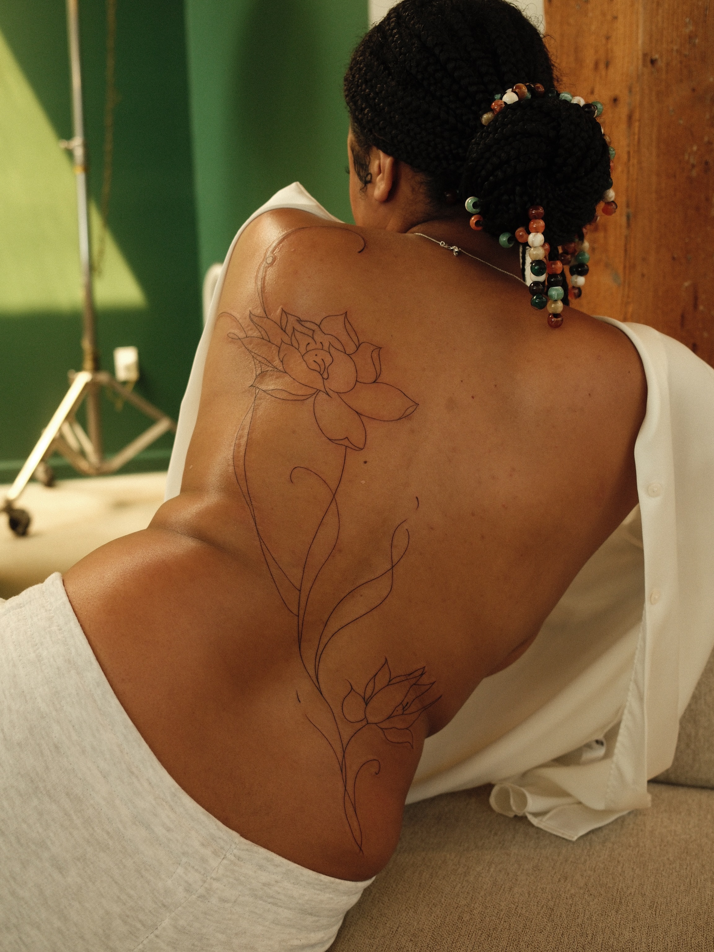 Lotus flower fine line tattoo on the back by v?