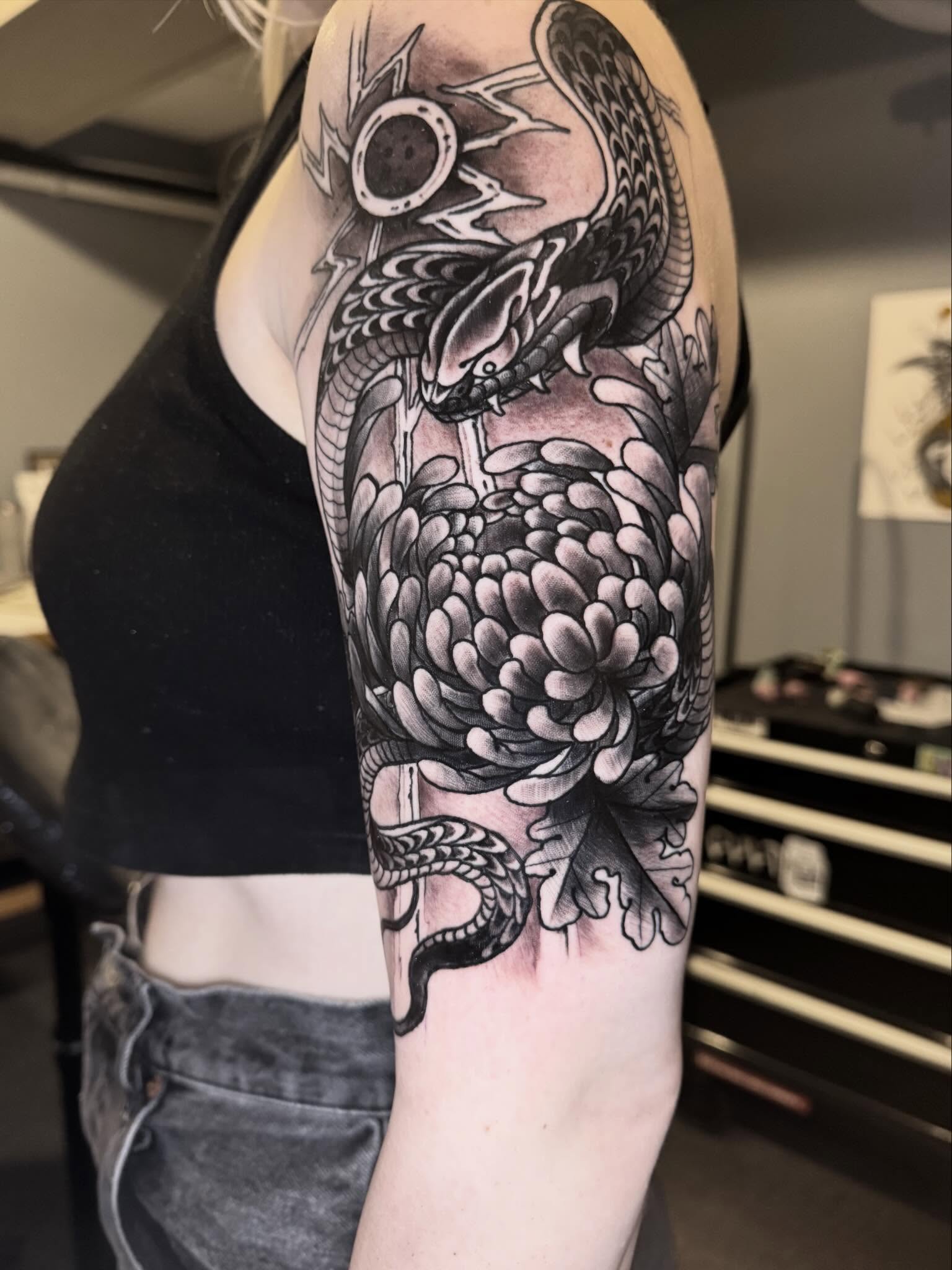 Snake and chrysanthemum japanese irezumi tattoo on the forearm by Mike Bean, Minneapolis, Minnesota