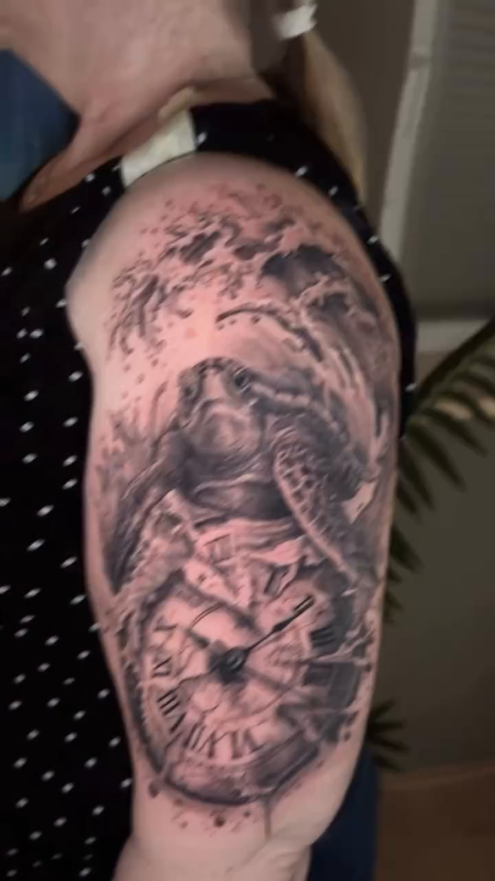 Turtle and clock with waves realism tattoo on the shoulder by Die Ivo, Bielefeld, Germany