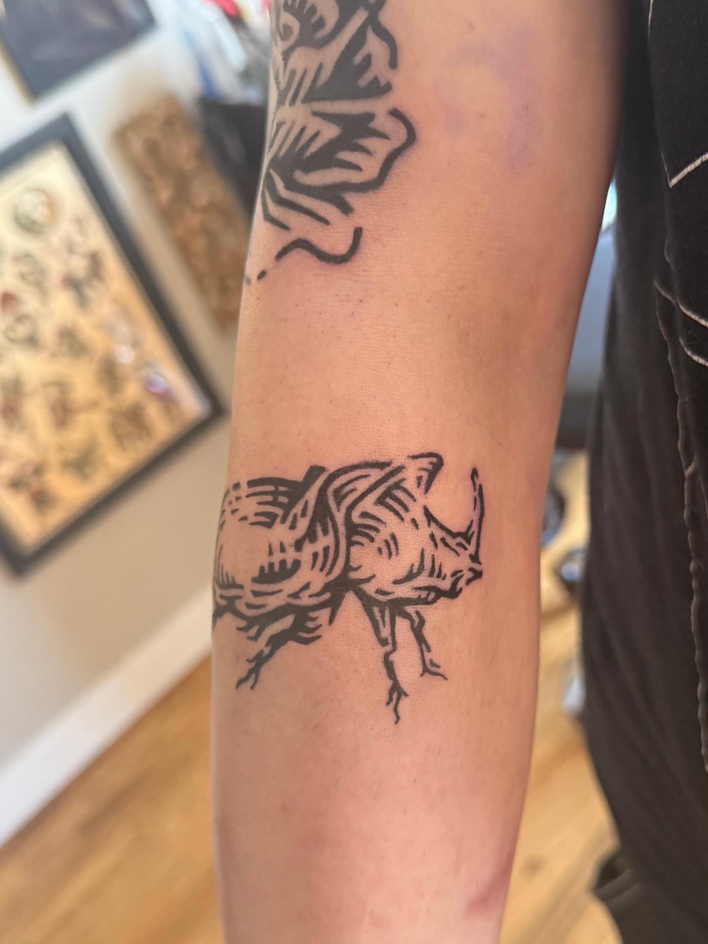 Rhinoceros black and grey tattoo on the forearm by M