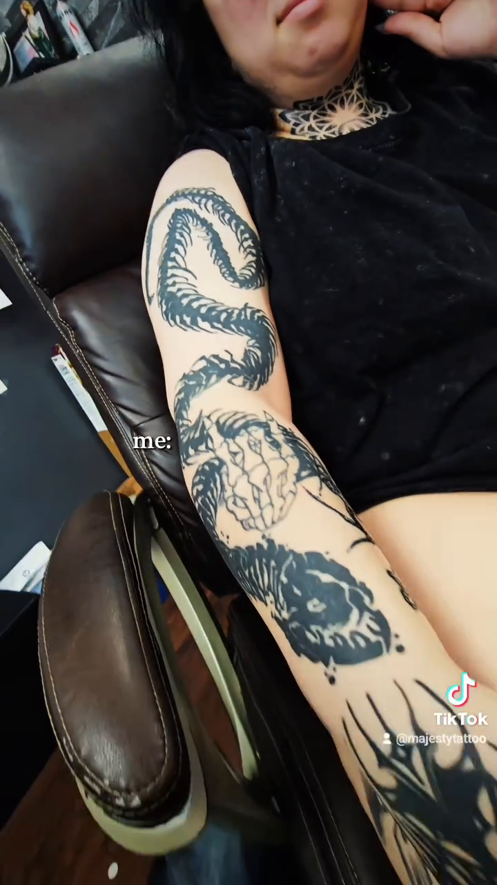 Biomechanical snake blackwork tattoo on the upper arm by Majesty Selvera