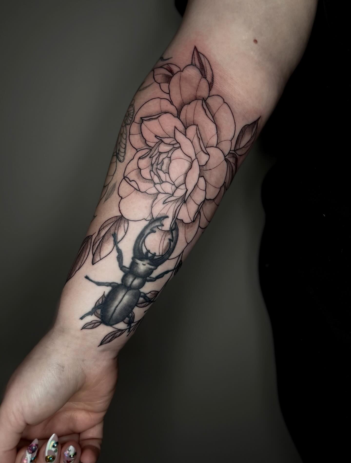 Stag beetle and flower realism tattoo on the forearm by Brandi 🕷, Mentor, Ohio