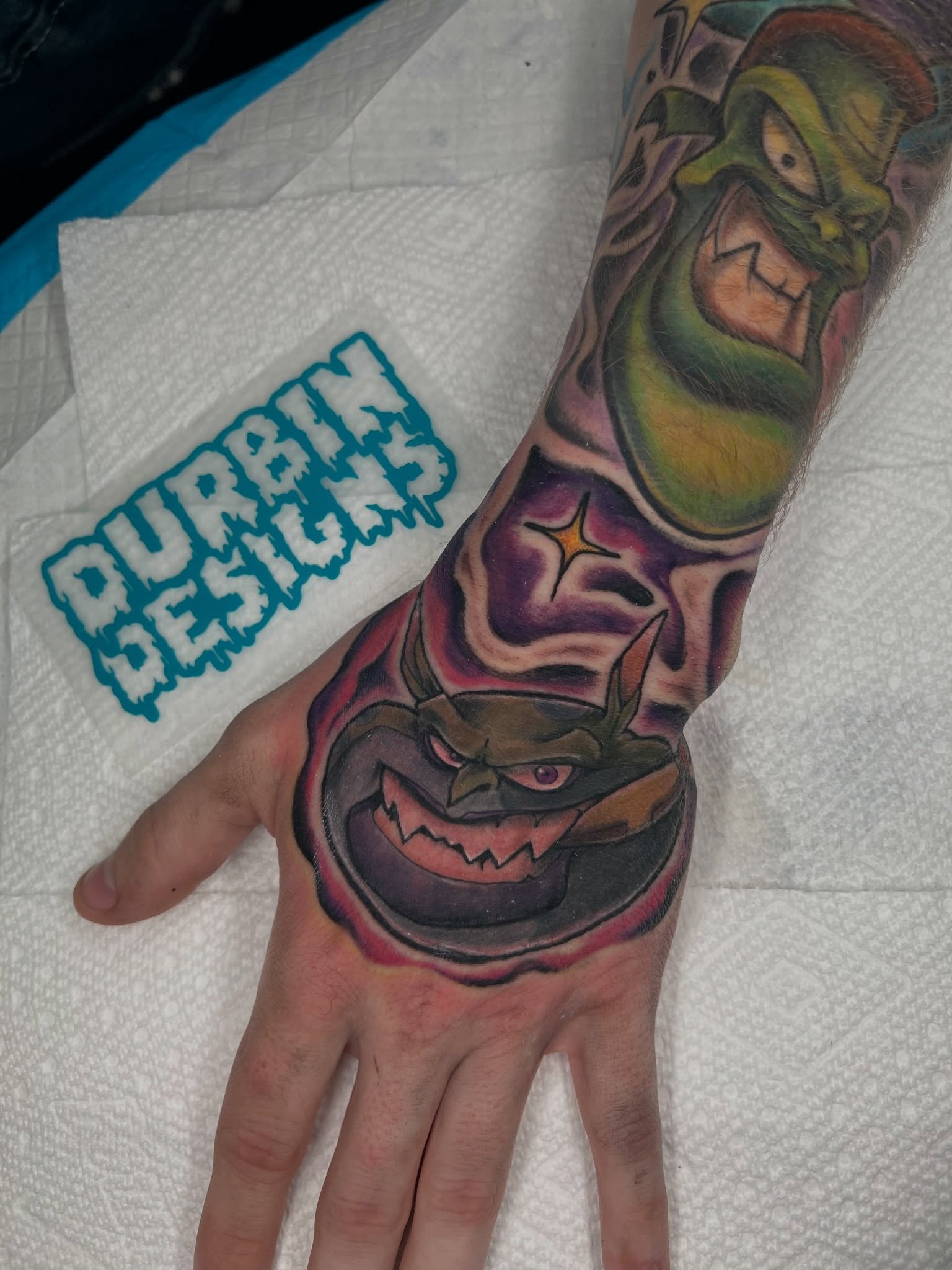 Angry mask American traditional tattoo on the hand by Brandon Durbin