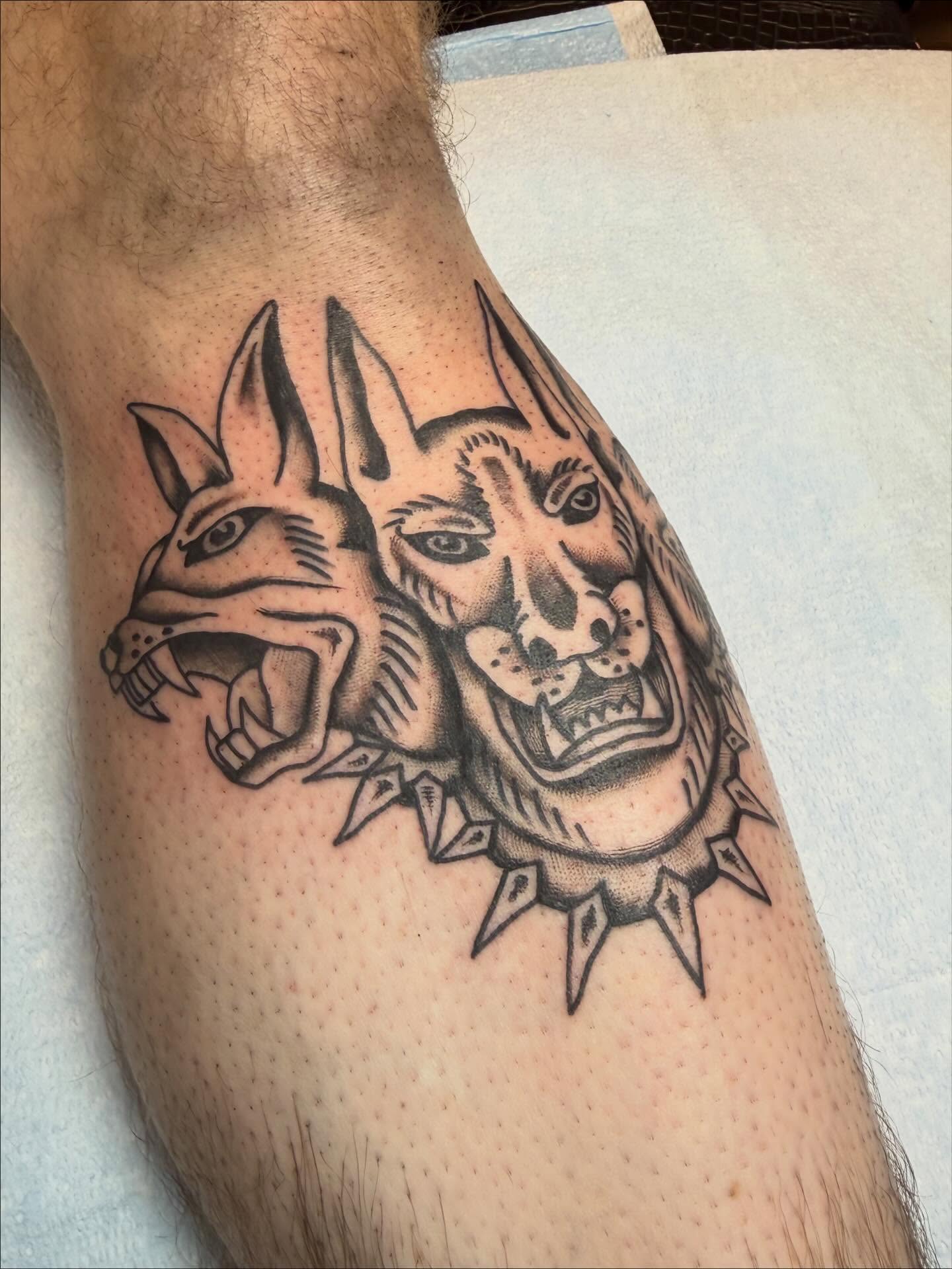 Wolf heads black and grey tattoo on the forearm by Jacqui Rose