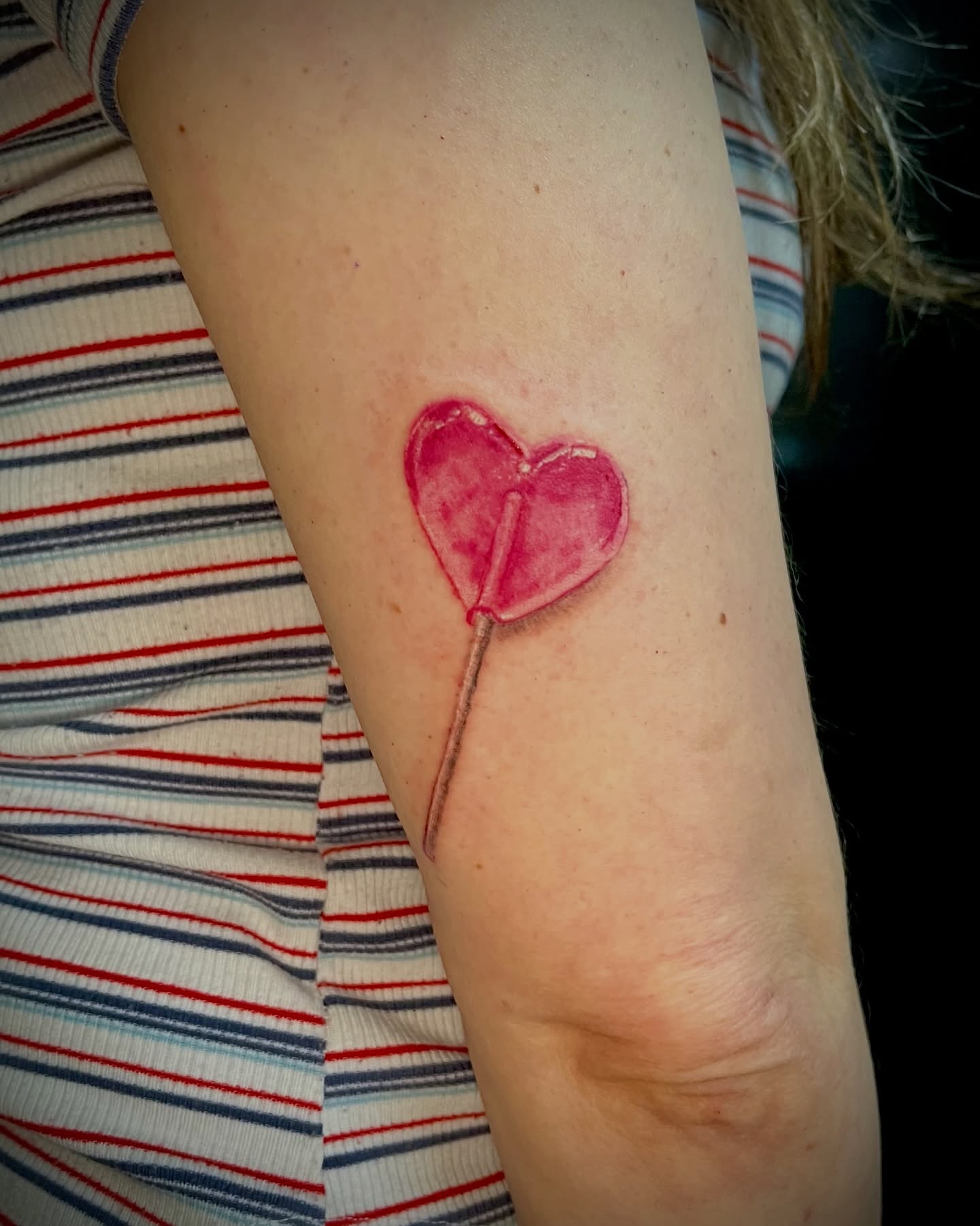 Heart lollipop watercolor tattoo on the forearm by EO, Chicago, Illinois