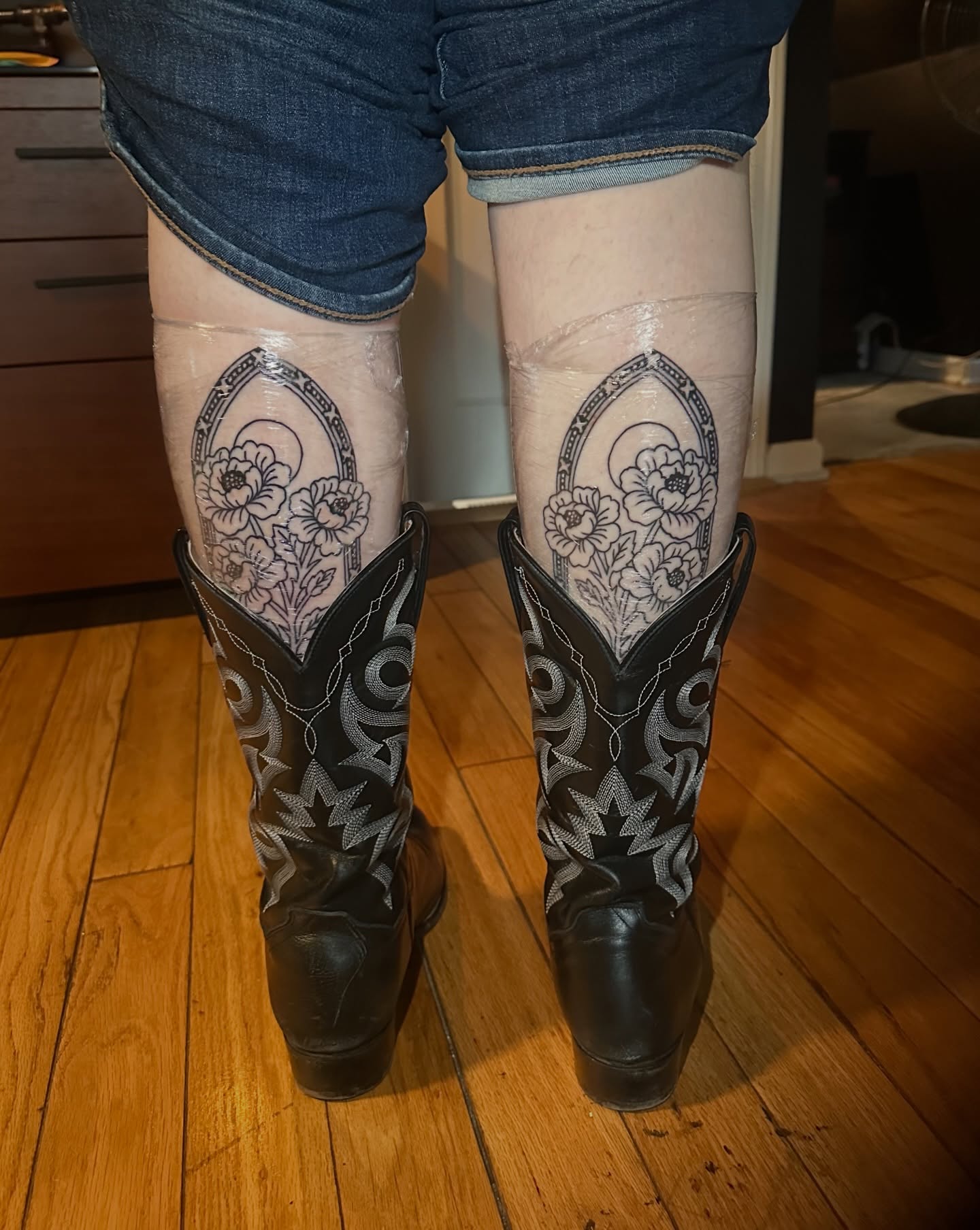 Floral design black and grey tattoo on the calf by Cory Wasmund (blue check)