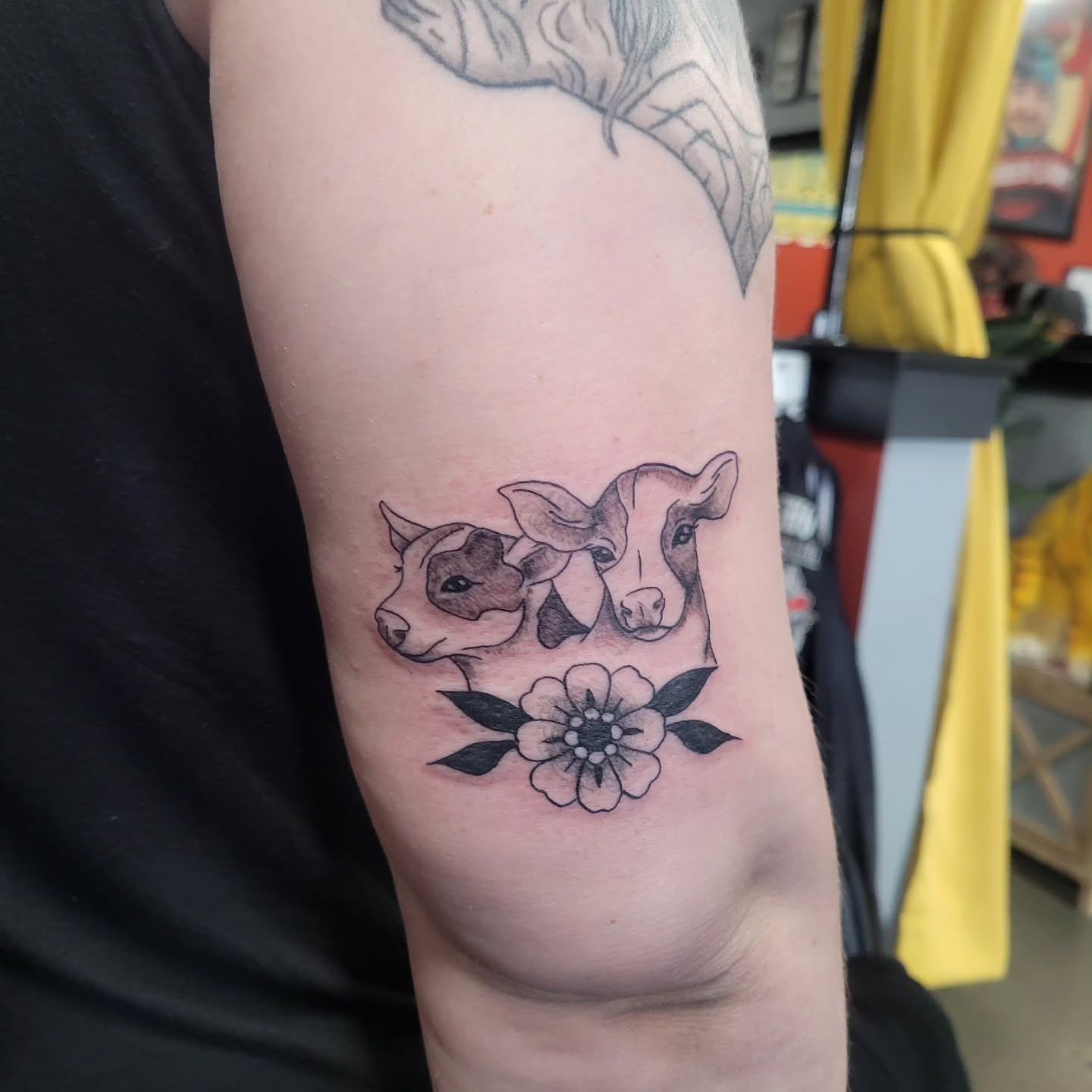 Cows and flower realism tattoo on the forearm by Aspen C