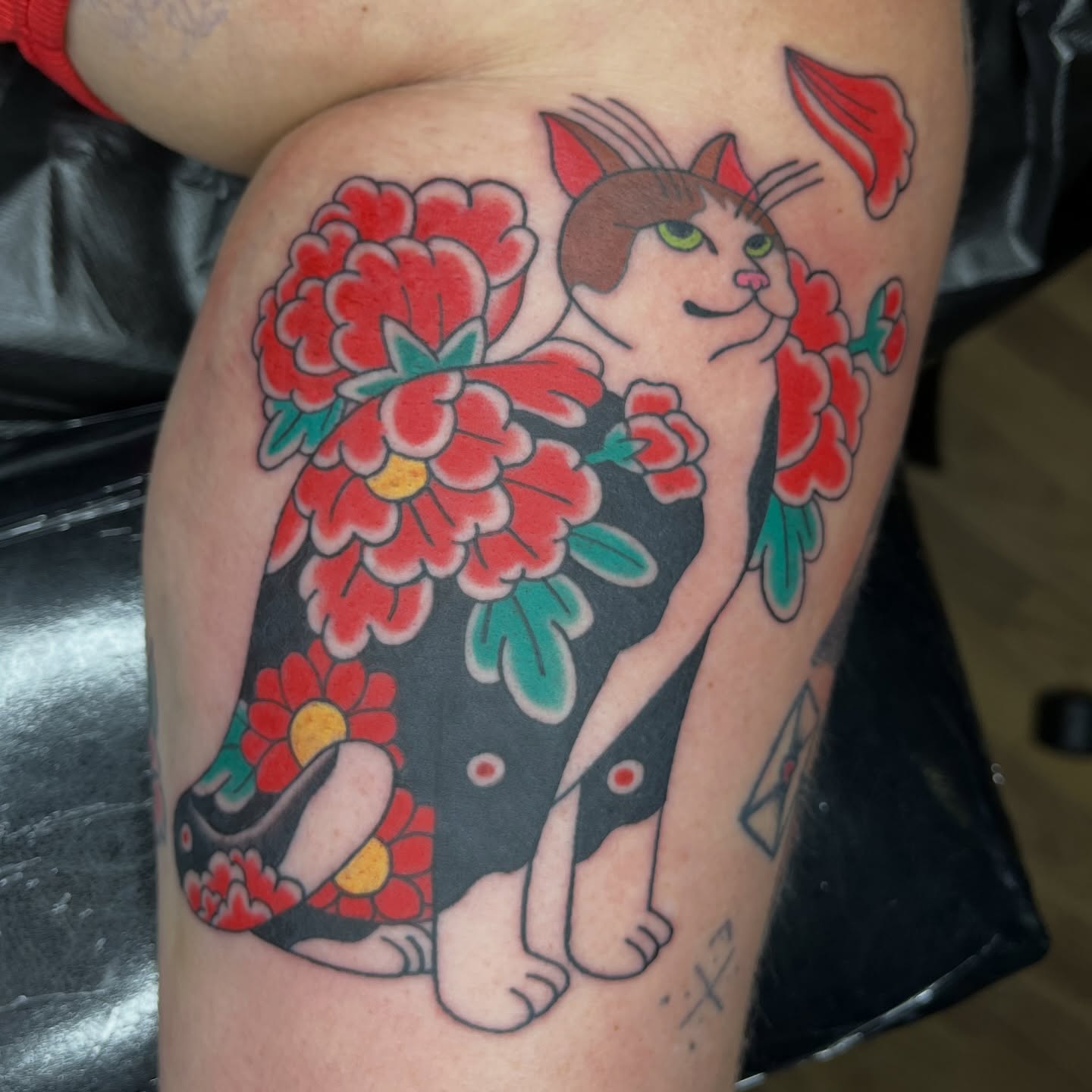 Cat and flowers American traditional tattoo on the thigh by Brian Easlon