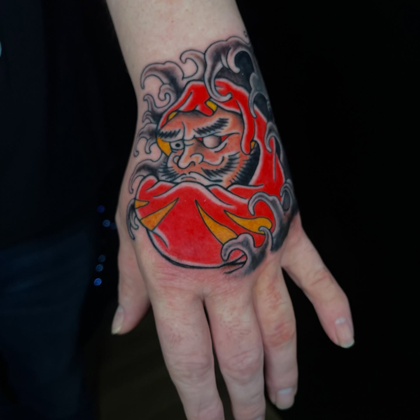 Red demon American traditional tattoo on the hand by Brian Easlon