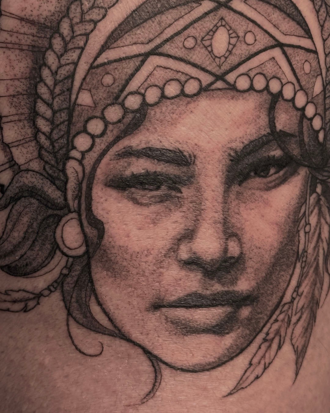 Woman's face realism tattoo on the chest by Erin Isaacs