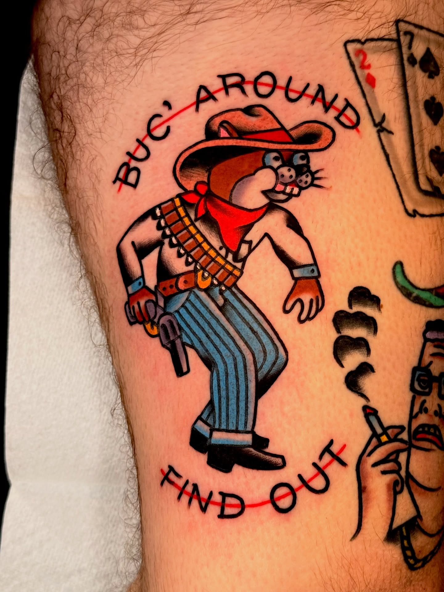 Cowboy cat American traditional tattoo on the thigh by {{Theo Glanton}}