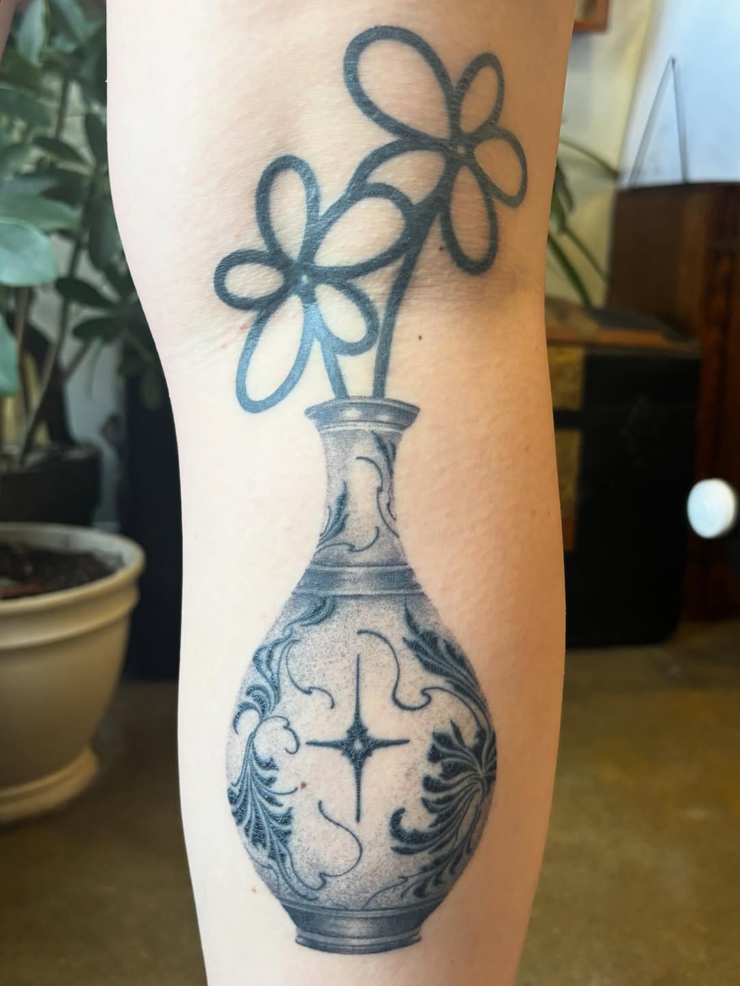 Vase with flowers surrealism tattoo on the forearm by Anna Kathleen, Des Moines, Iowa