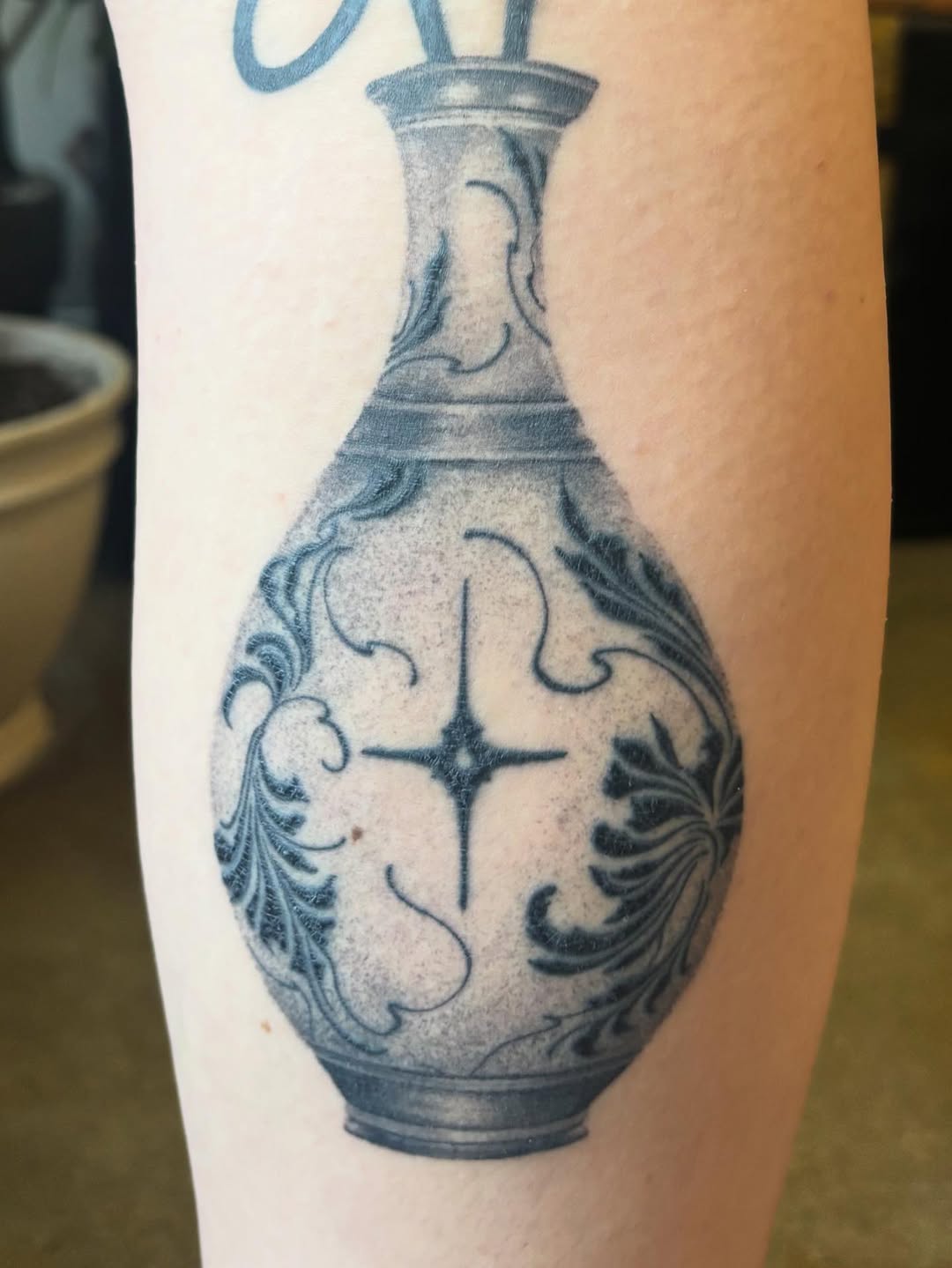 Ornate vase with starburst surrealism tattoo on the forearm by Anna Kathleen, Des Moines, Iowa
