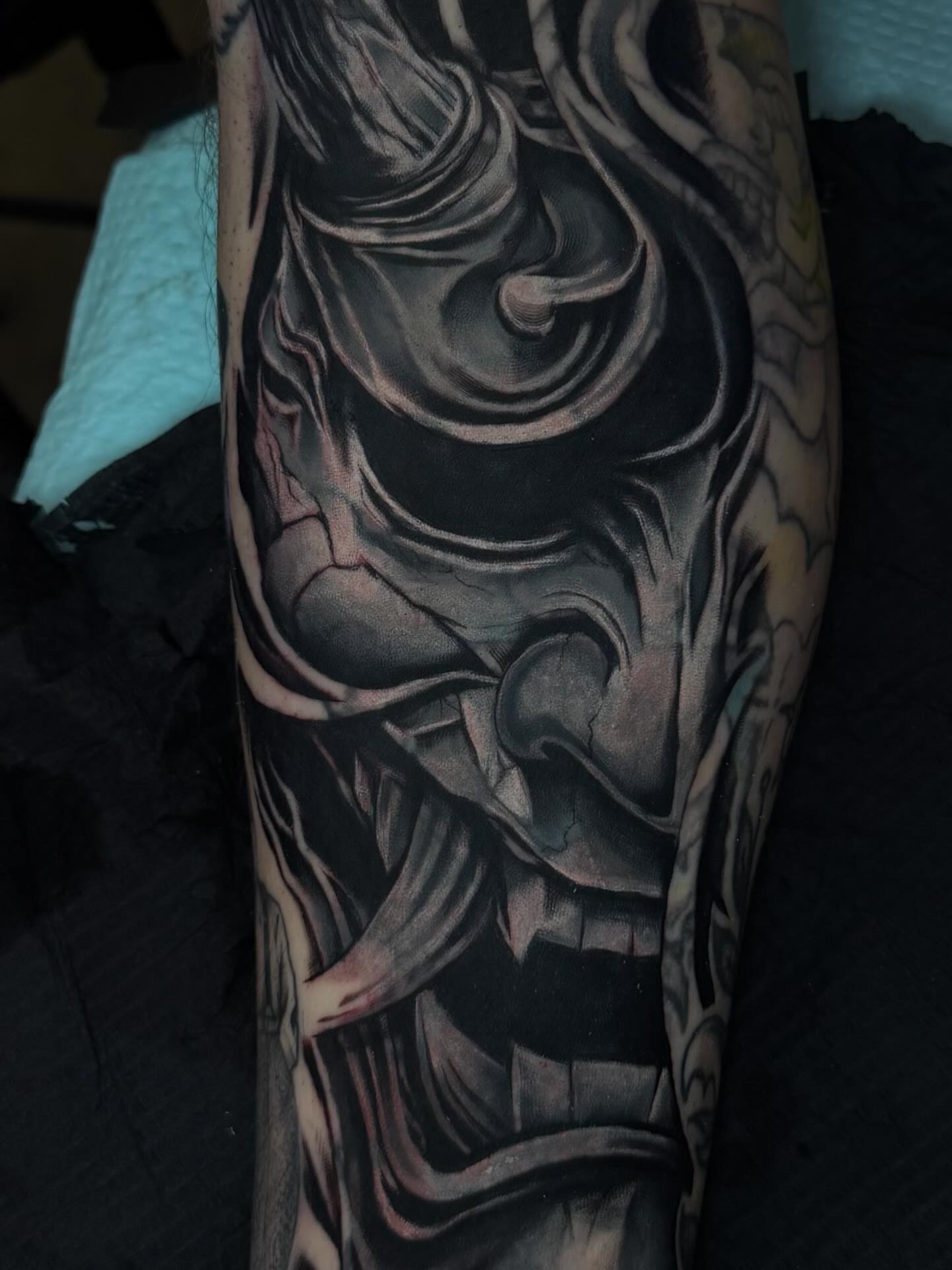 Abstract figure dark realism tattoo on the forearm by Lu Ve, Dayton, Ohio