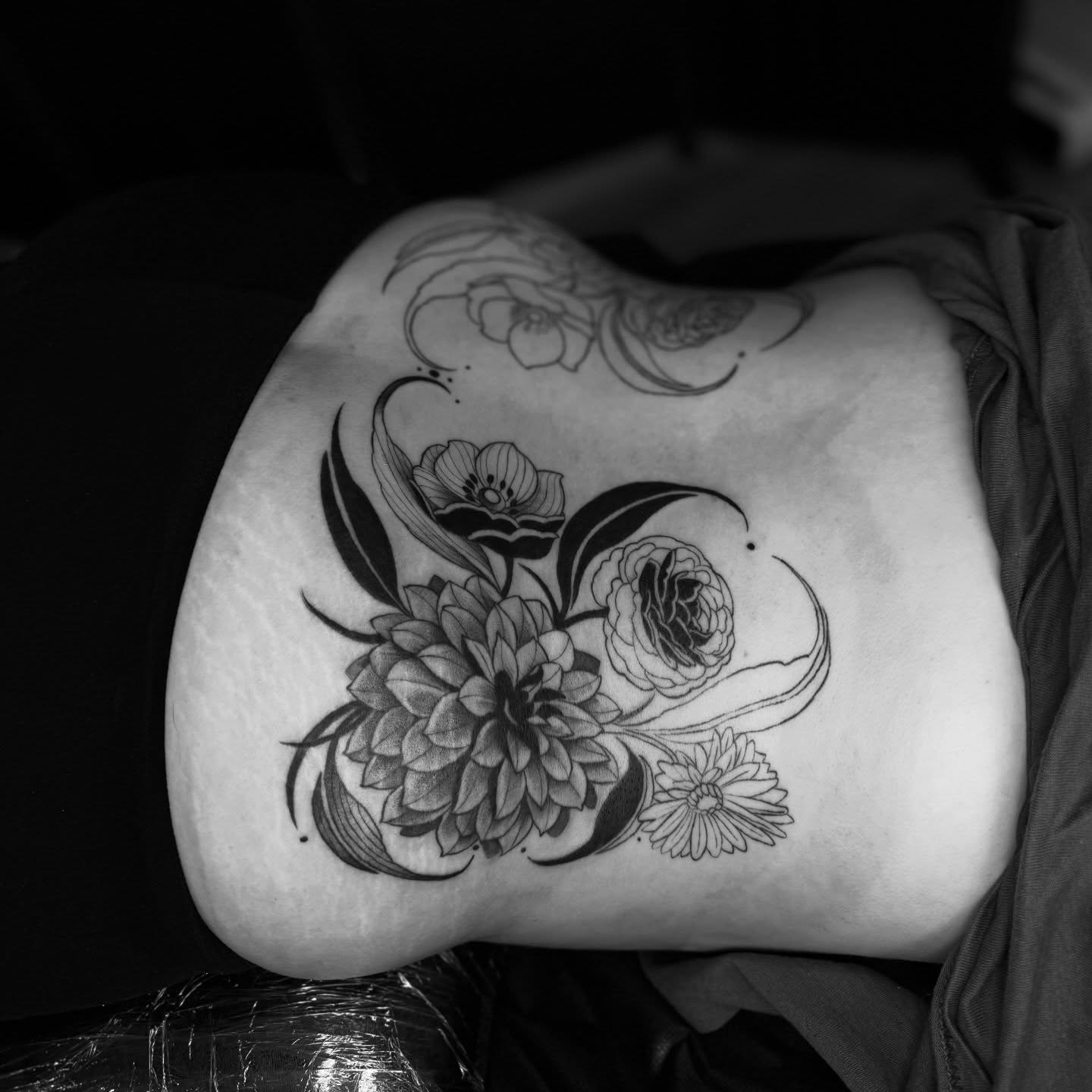 Floral bouquet realism tattoo on the ribs by Kait