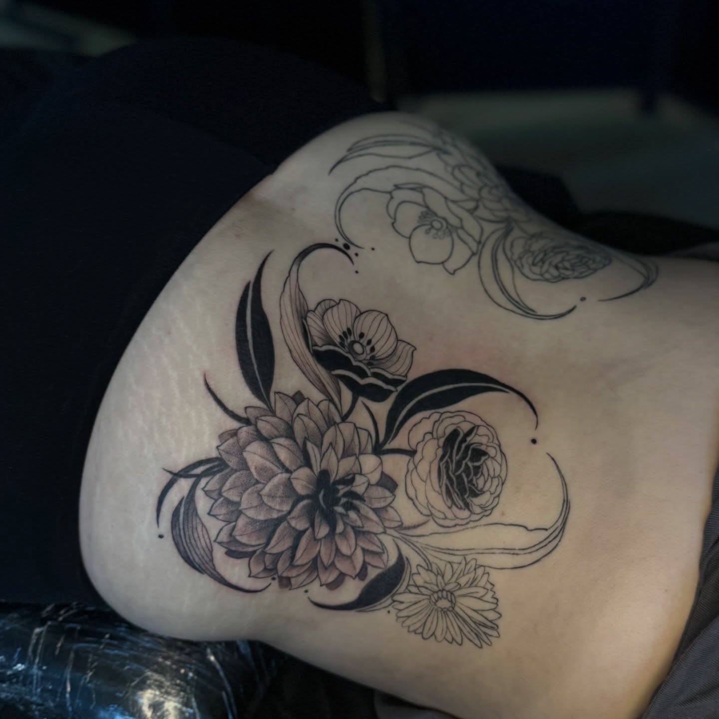 Floral arrangement black and grey tattoo on the shoulder by Kait