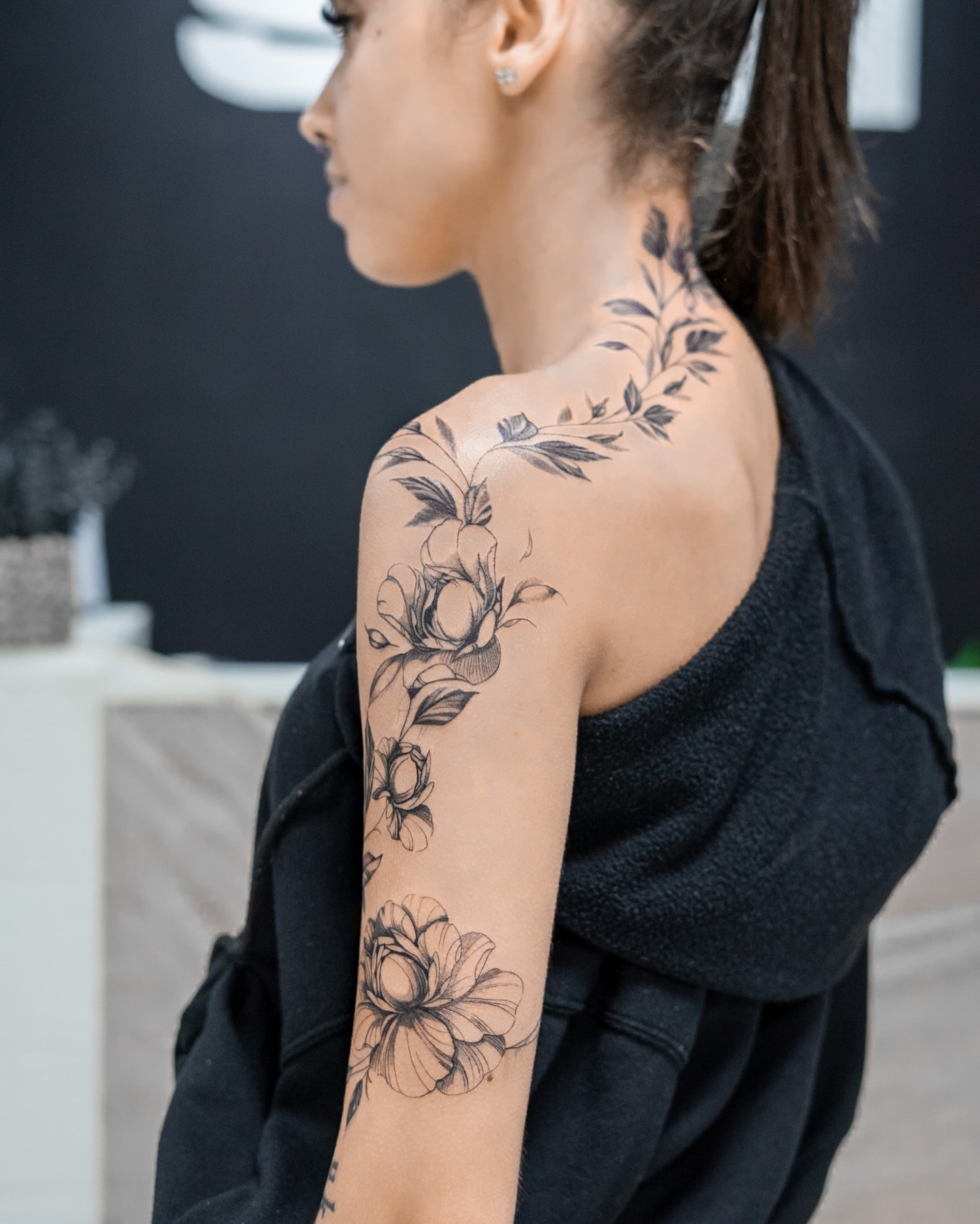 Floral design black and grey tattoo on the shoulder by The Tattoo Plug