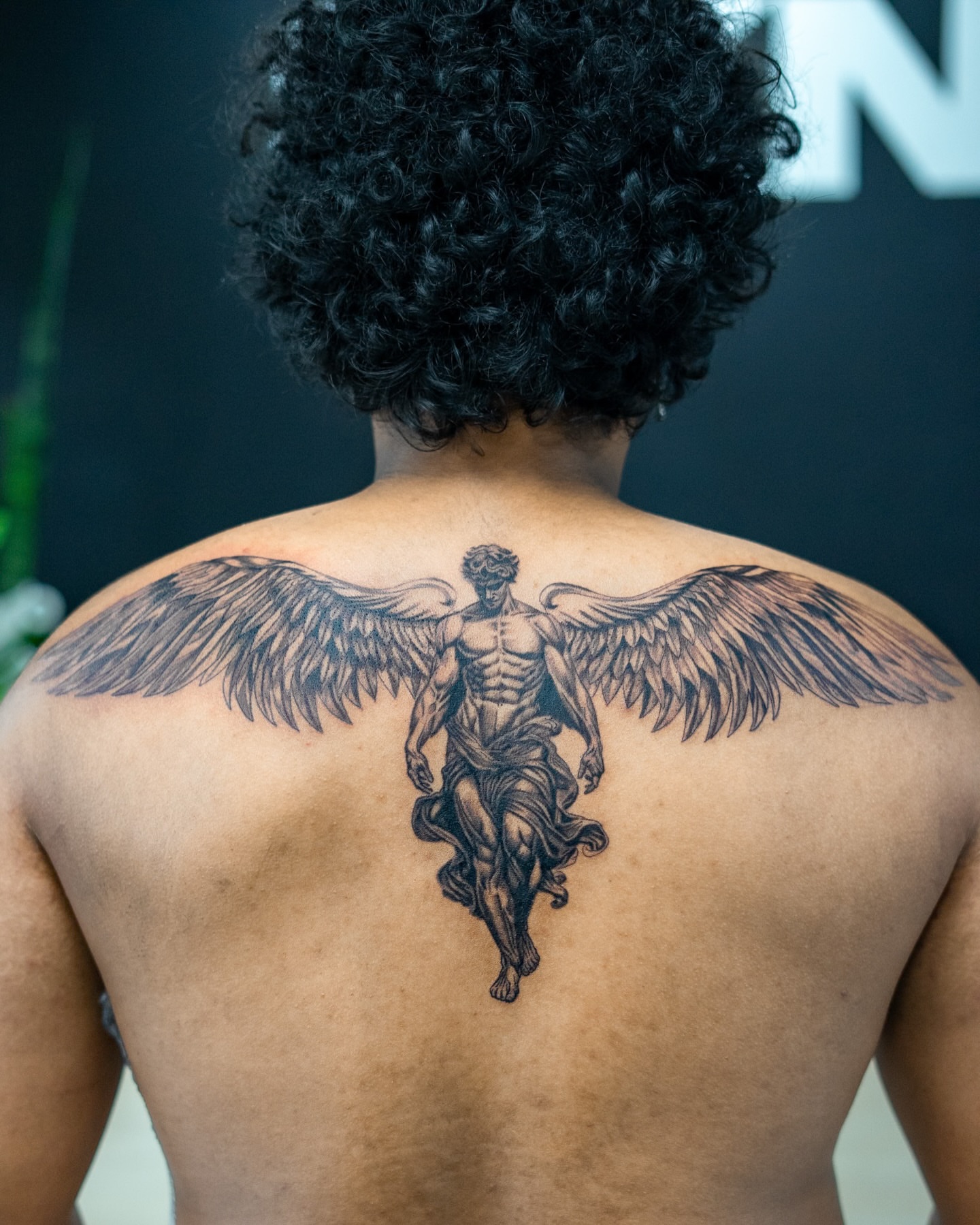 Winged angel black and grey tattoo on the back by The Tattoo Plug