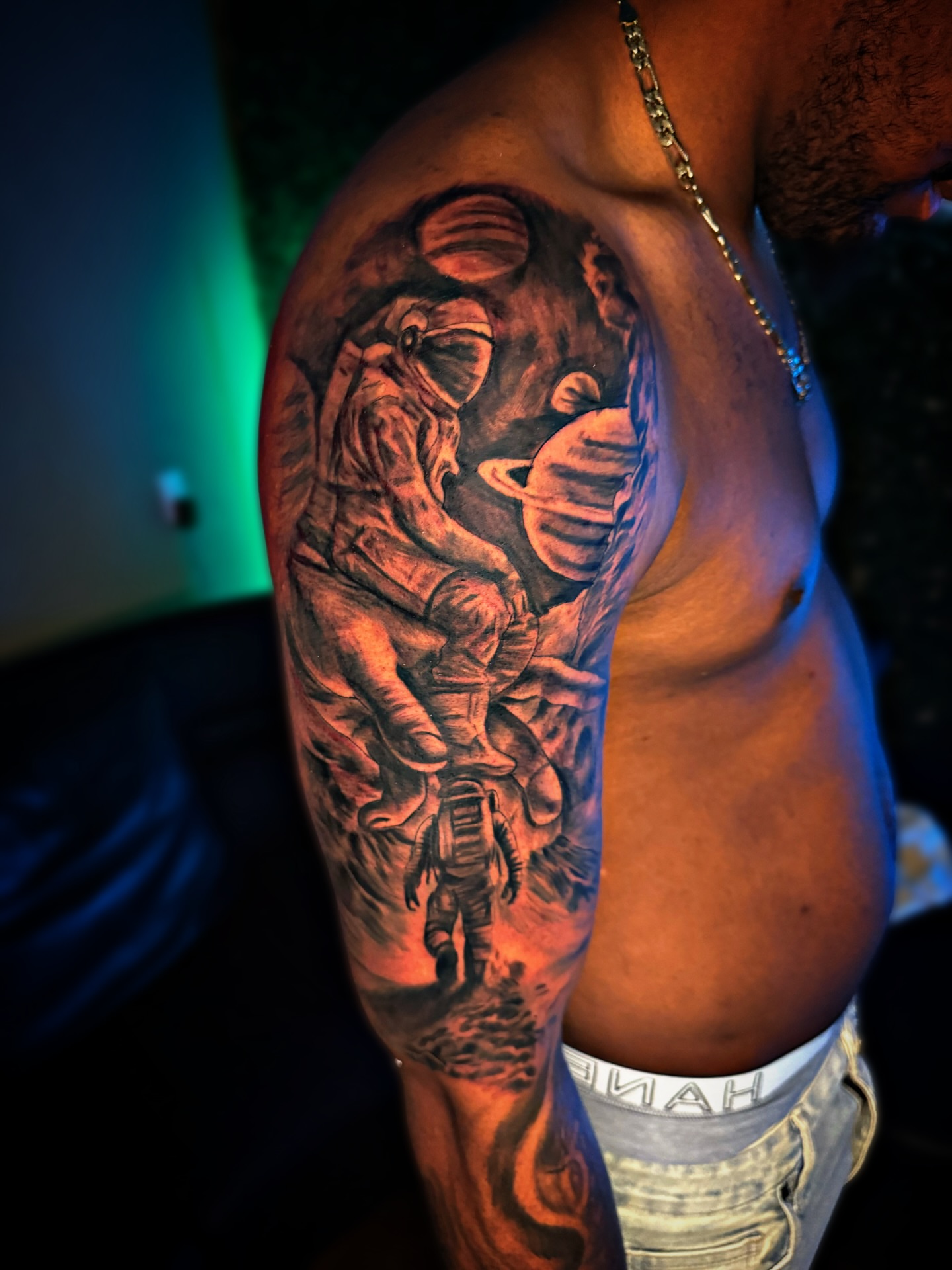 Astronaut and planet realism tattoo on the upper arm by Dallas Tattoo Artist📍