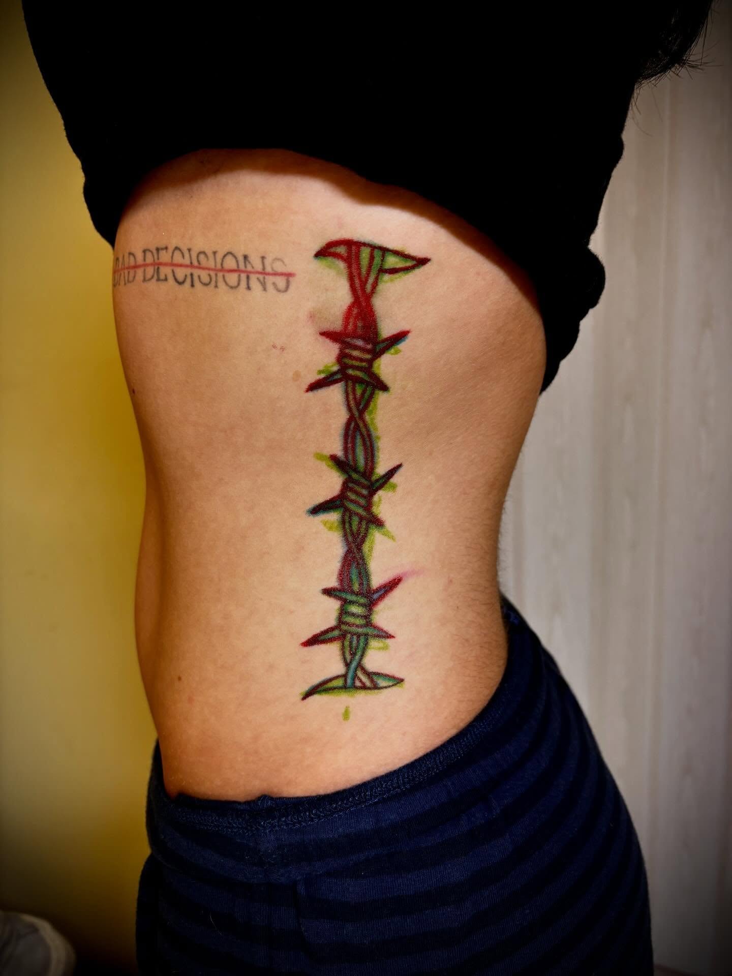 Barbed wire neo-traditional tattoo on the ribs by JD Bassett